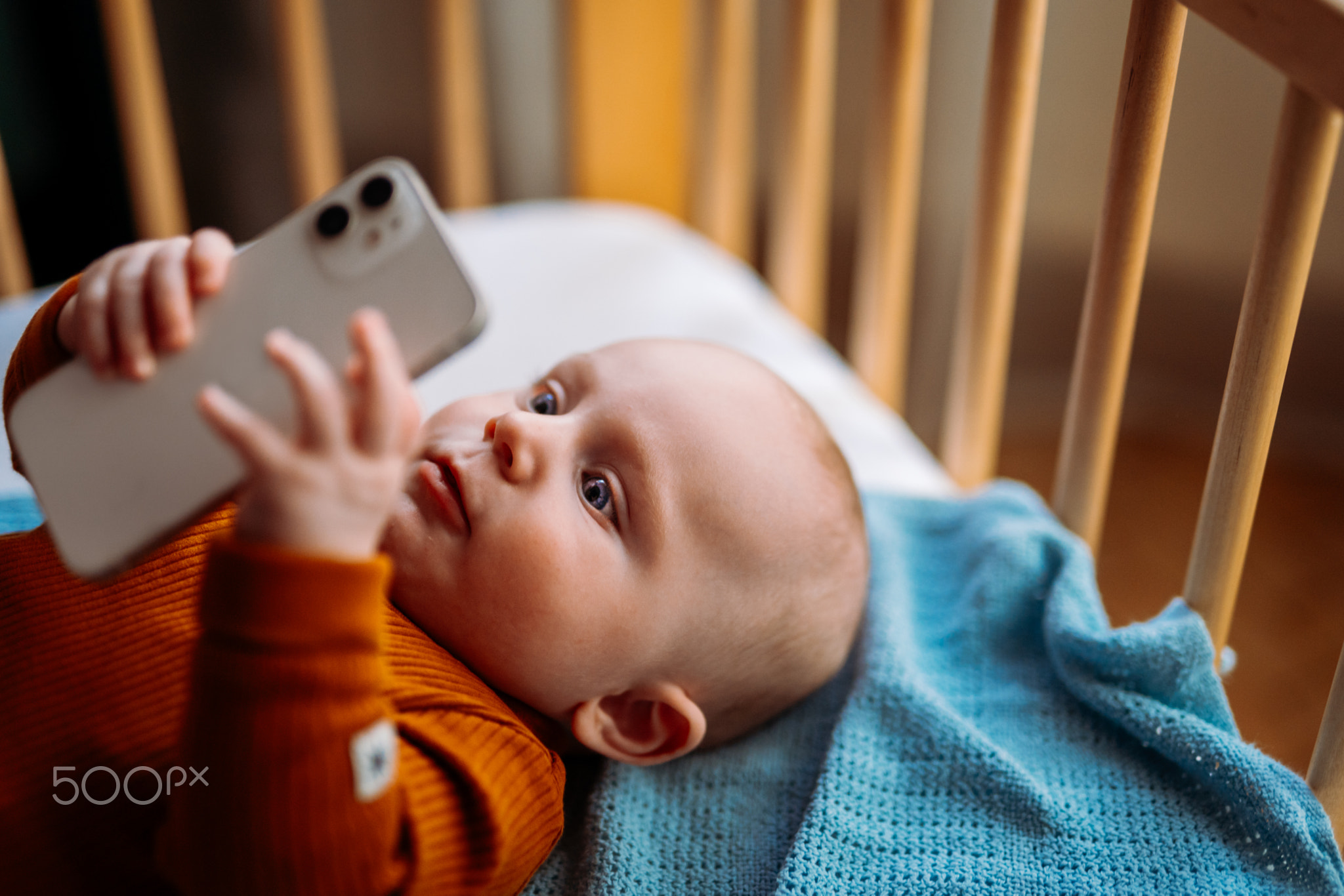 Baby toddler holding smartphone. Watching a video on smartphone.