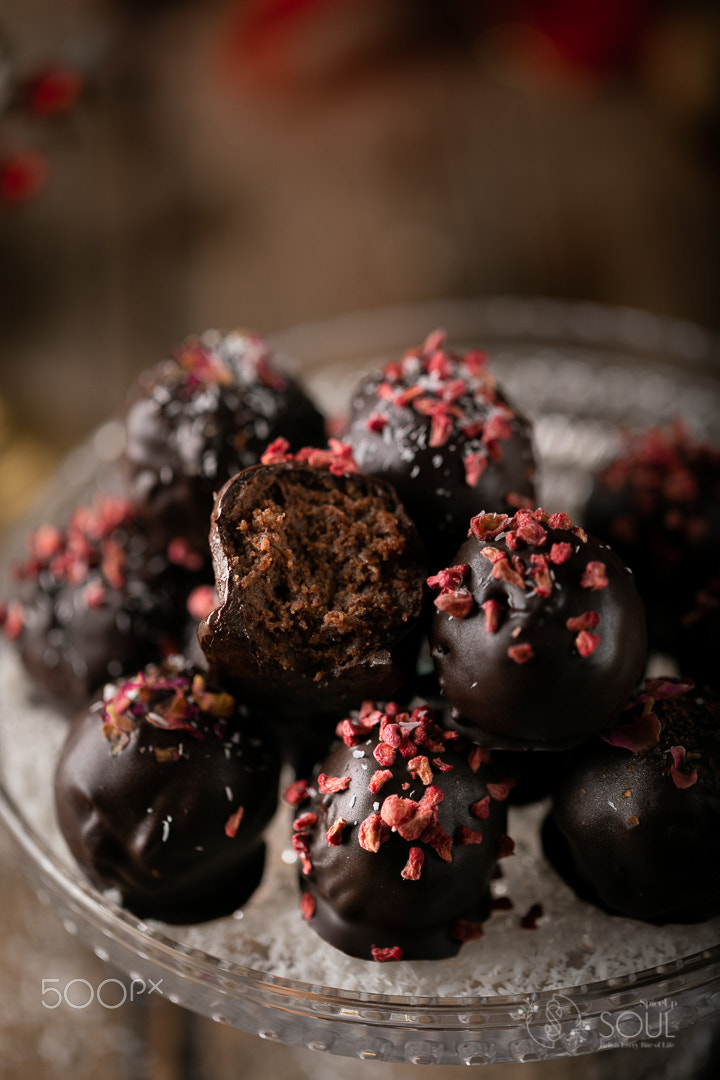 group of chocolate truffles with frozen raspberries