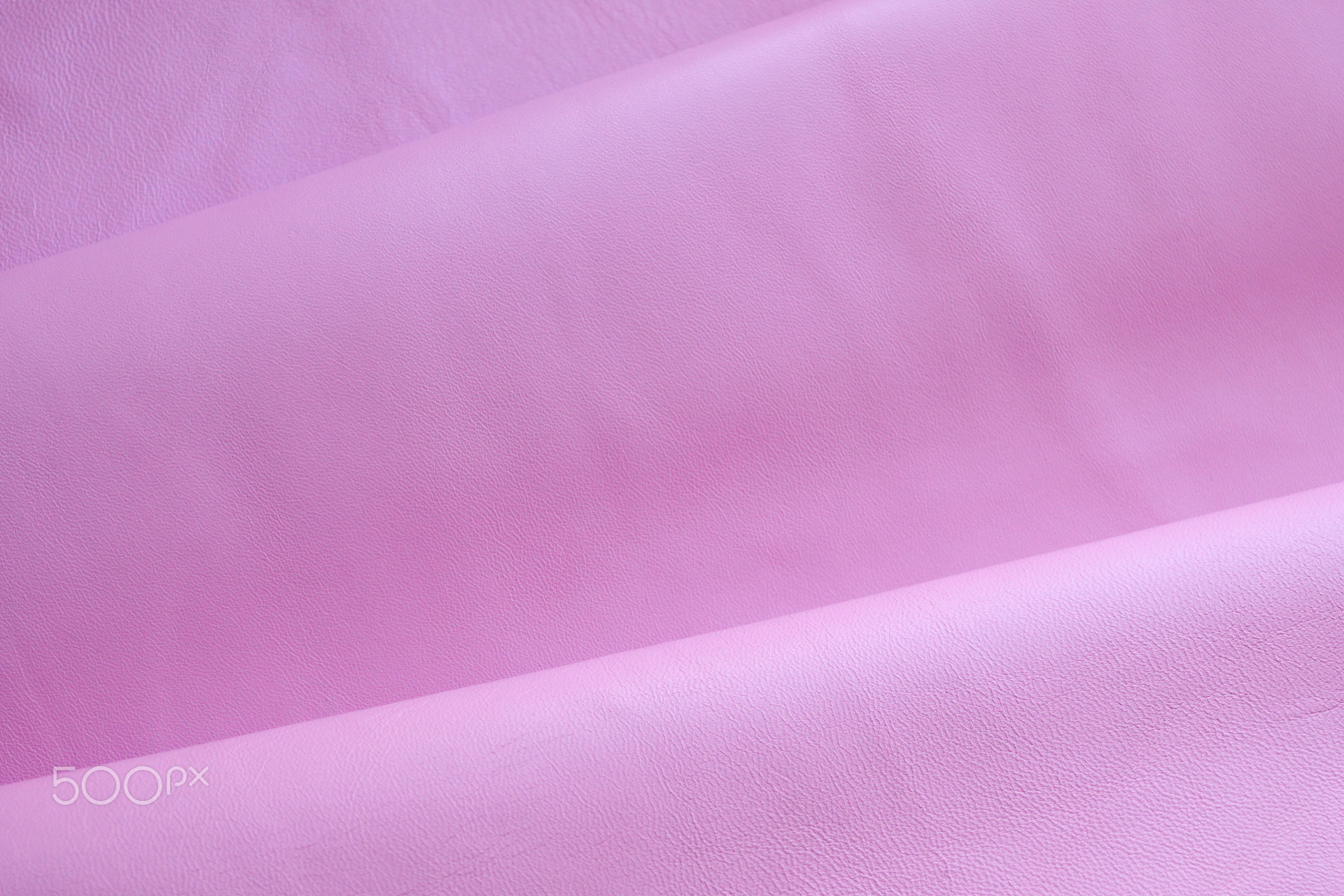 Close up background of soft nappa leather in pink color.