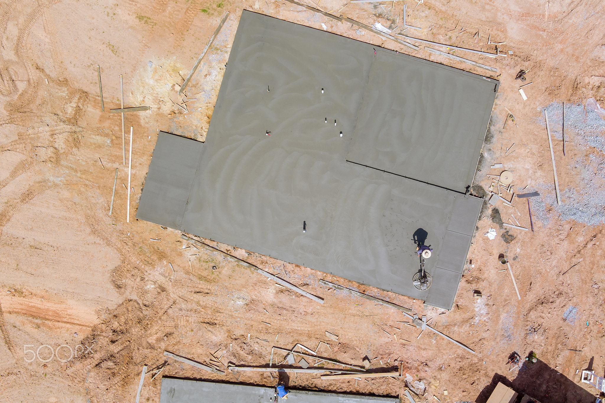 Aerial view of construction worker using machine application grinding