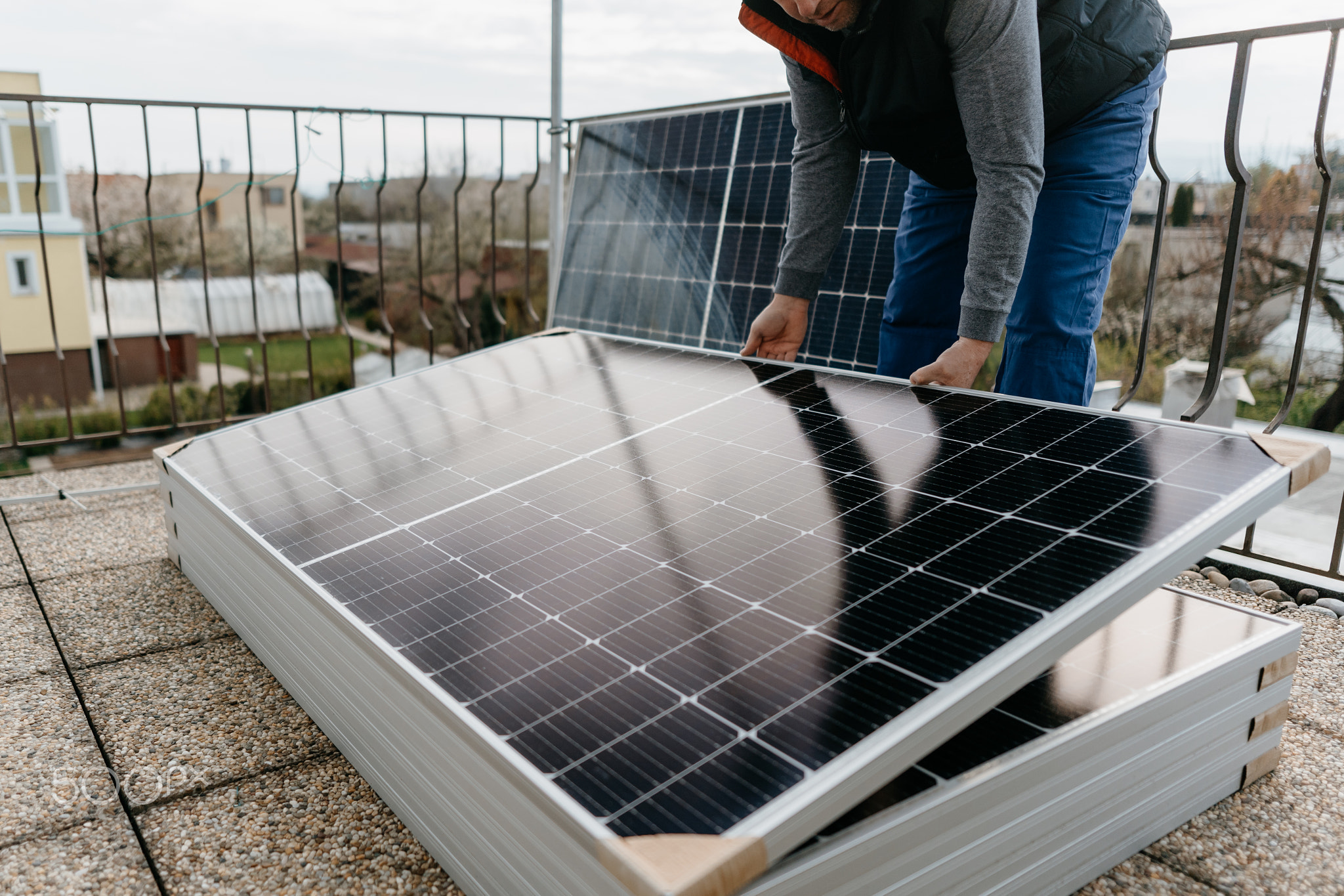 Man holds the solar panel and sets the correct position. Green energy