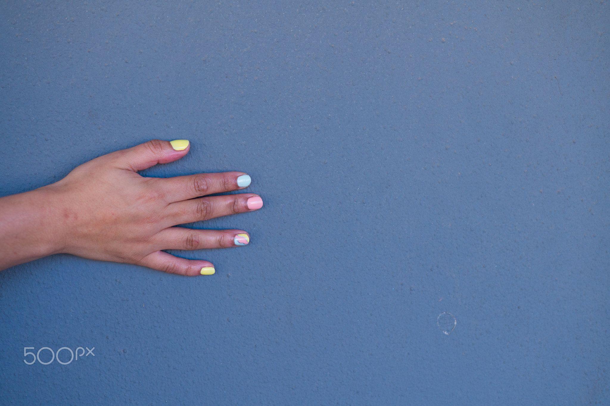 Close up shot of woman with pastel colored nails