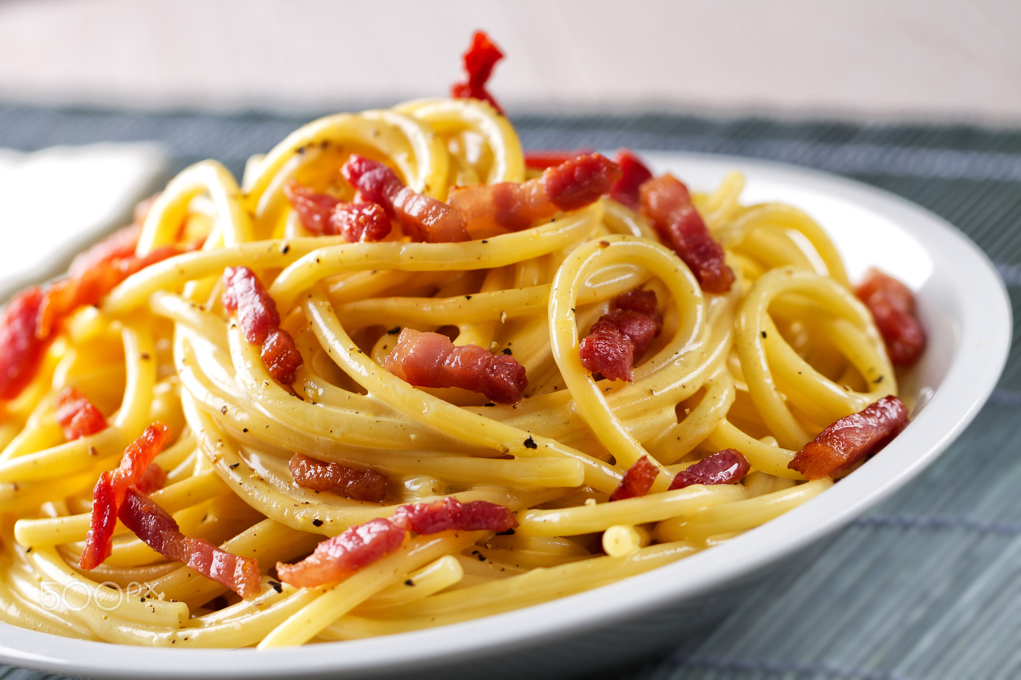 Traditional italian dish spaghetti carbonara with bacon in a cream