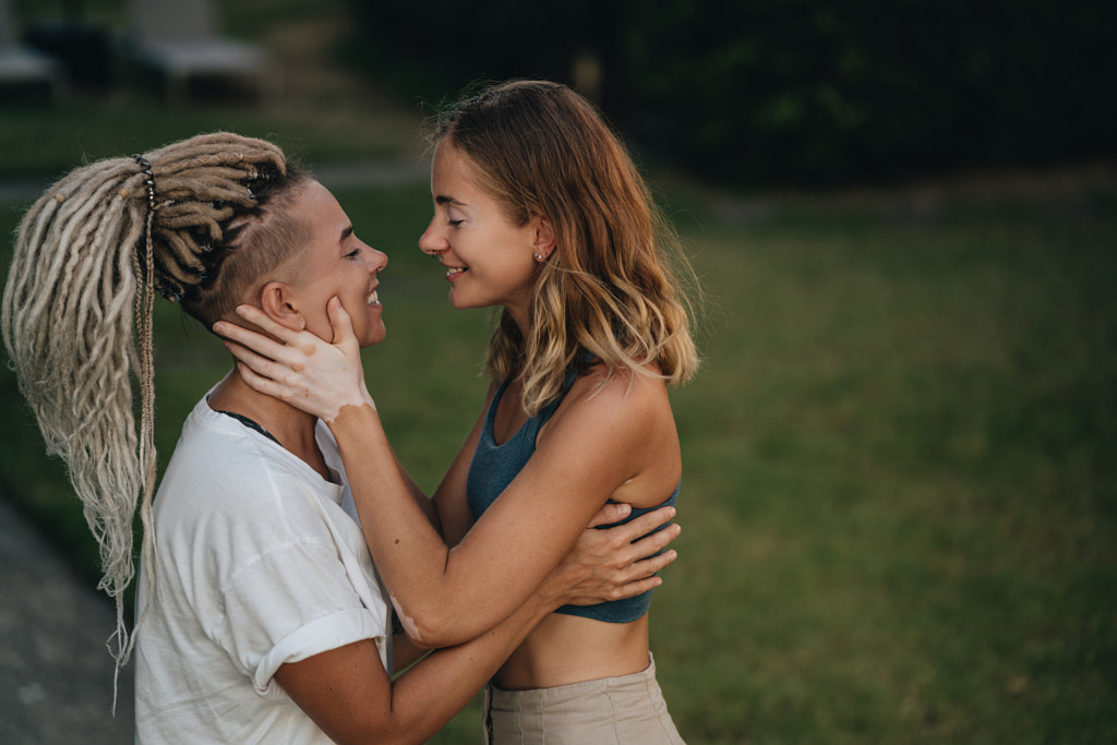 Happy lesbian couple hugging in a garden by Natalie Zotova on 500px.com