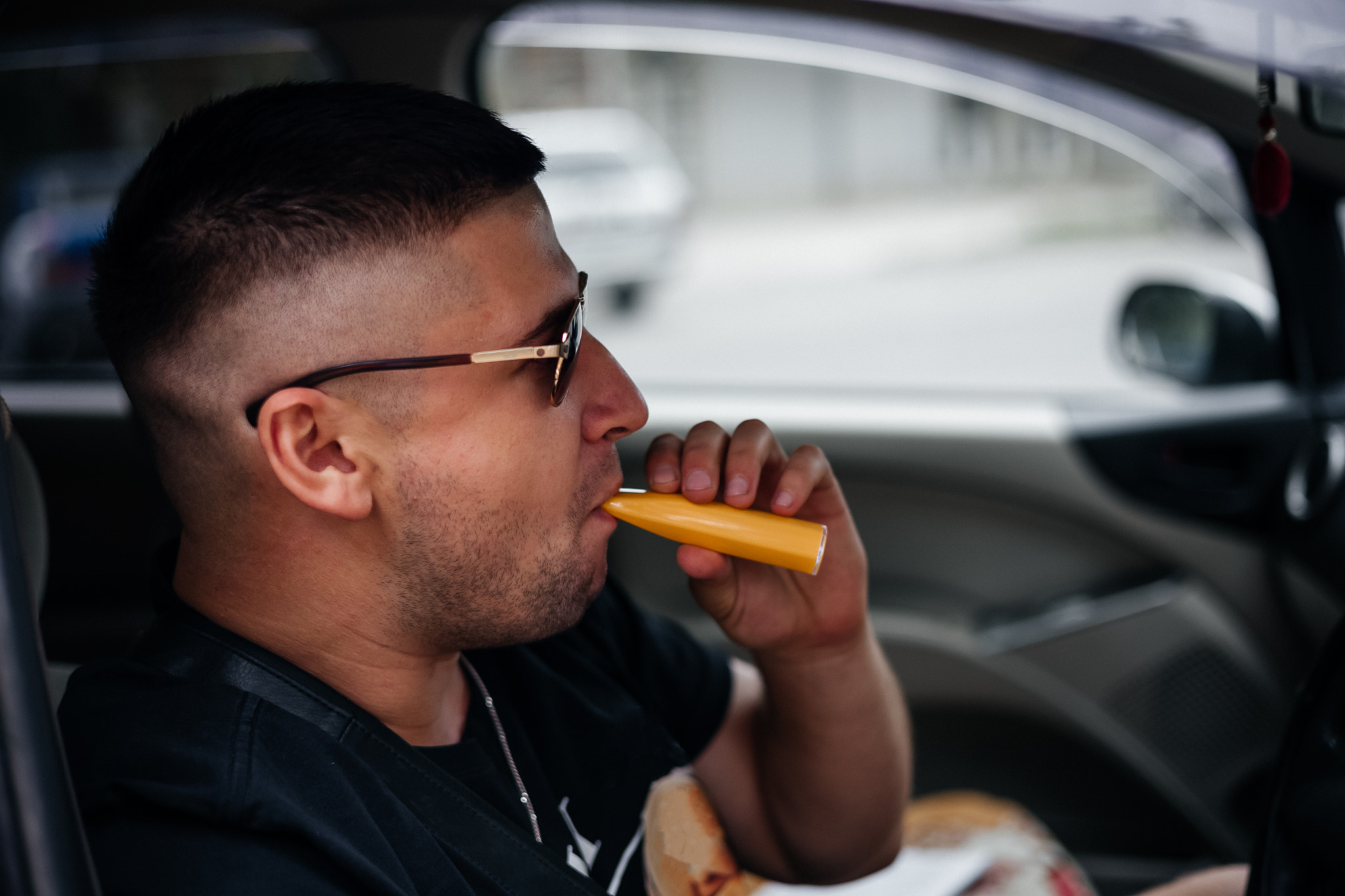 young man smoking an e-cigarette . close up portrait .Vaping an electronic cigarette