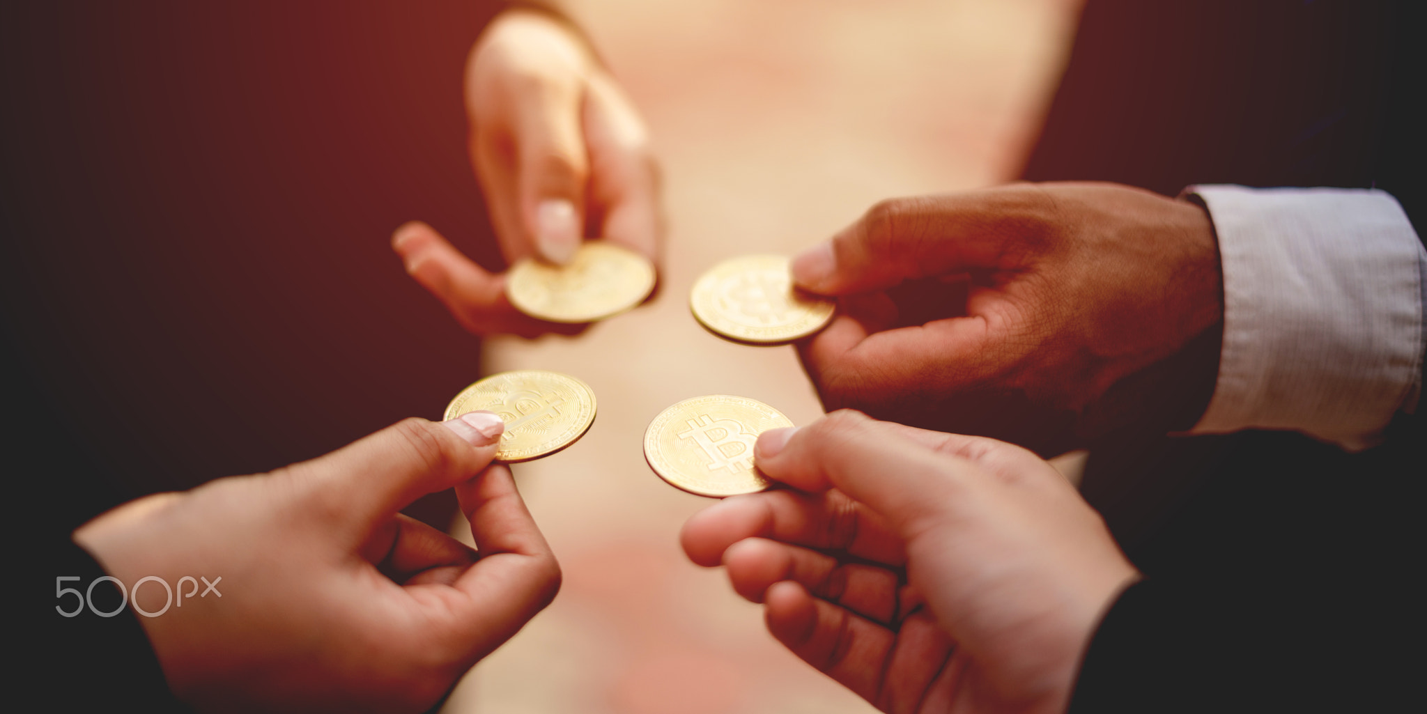 Close-up photo of Bitcoin, business people holding coins together Cryptocurrency Market Trends