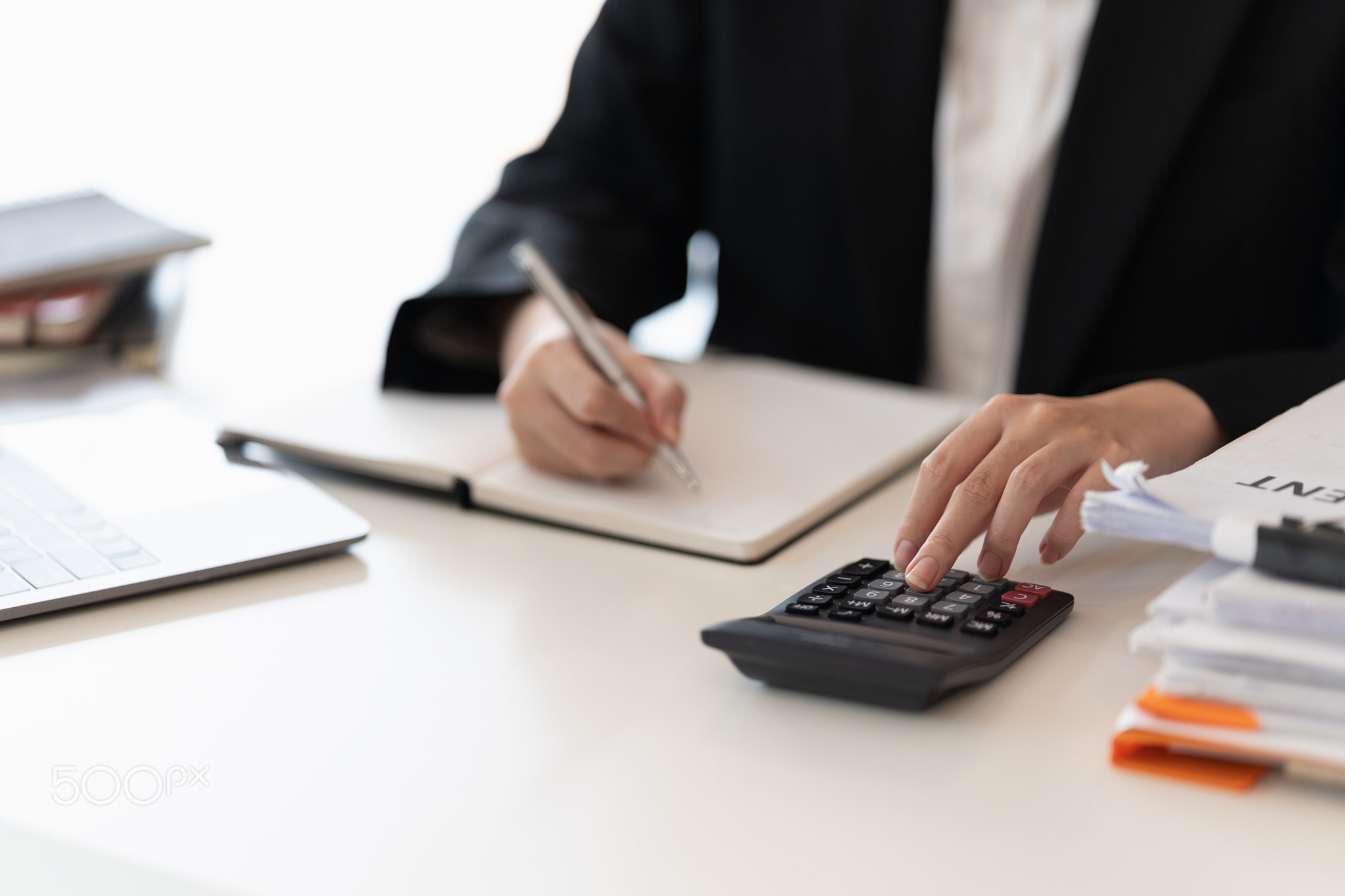 Close up view of bookkeeper or financial inspector hands making report