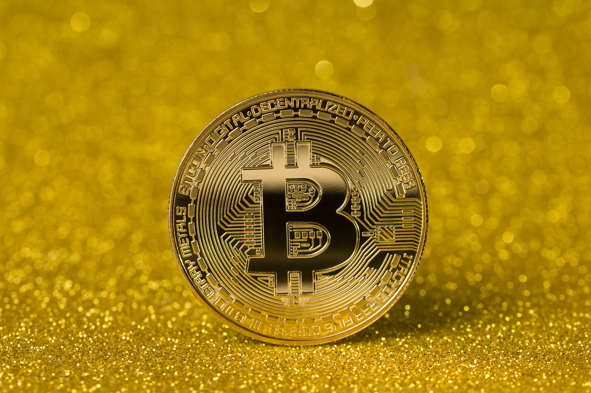 cryptocurrency coin concept .Bitcoin And Bokeh Light On Gold Background