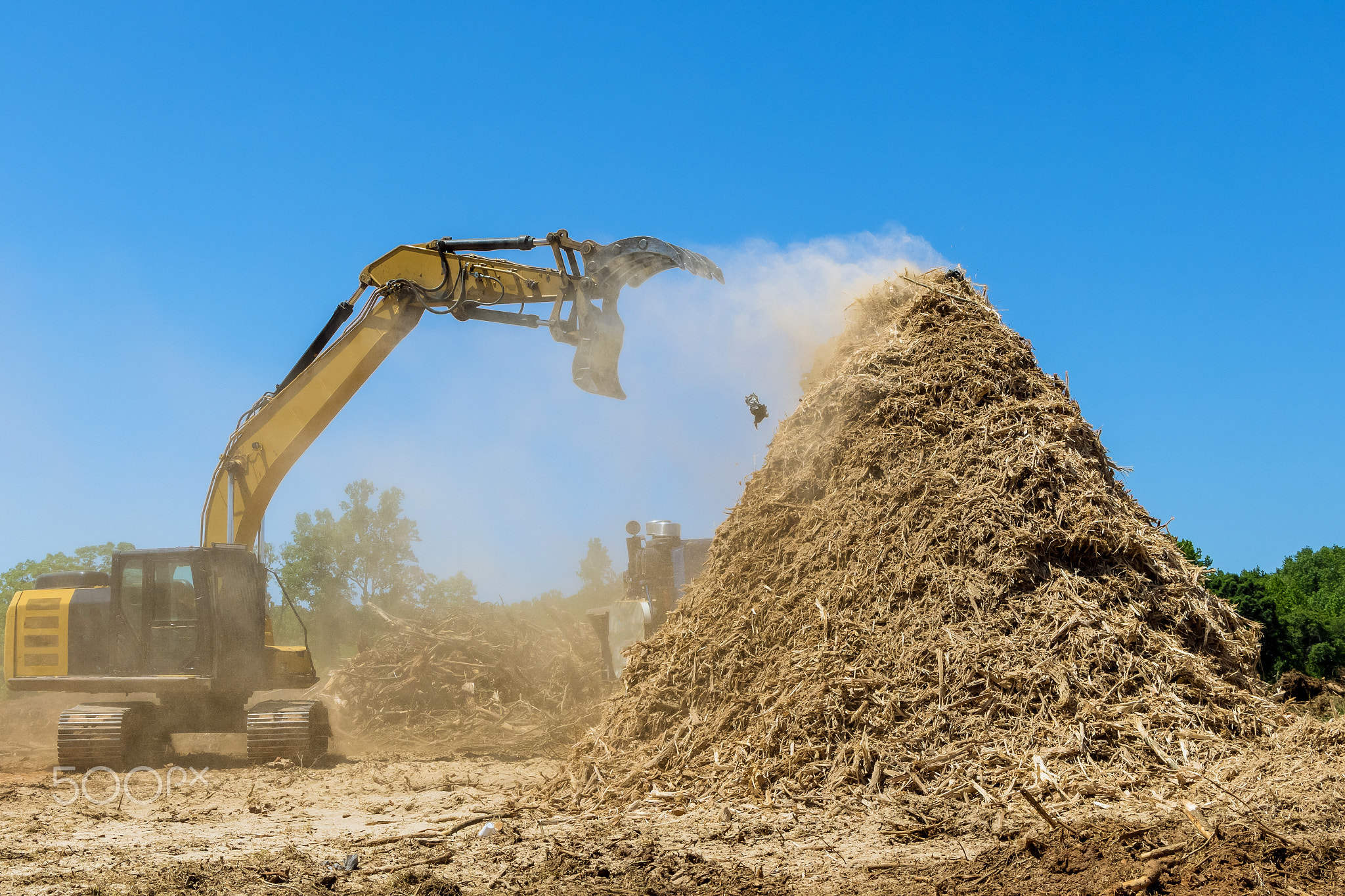 Construction site area in wood chipper machine with mulch an work