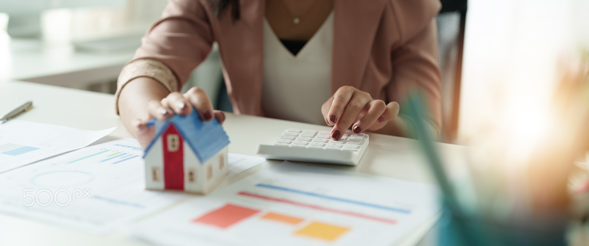 Businesswoman working doing finances and calculation cost of real