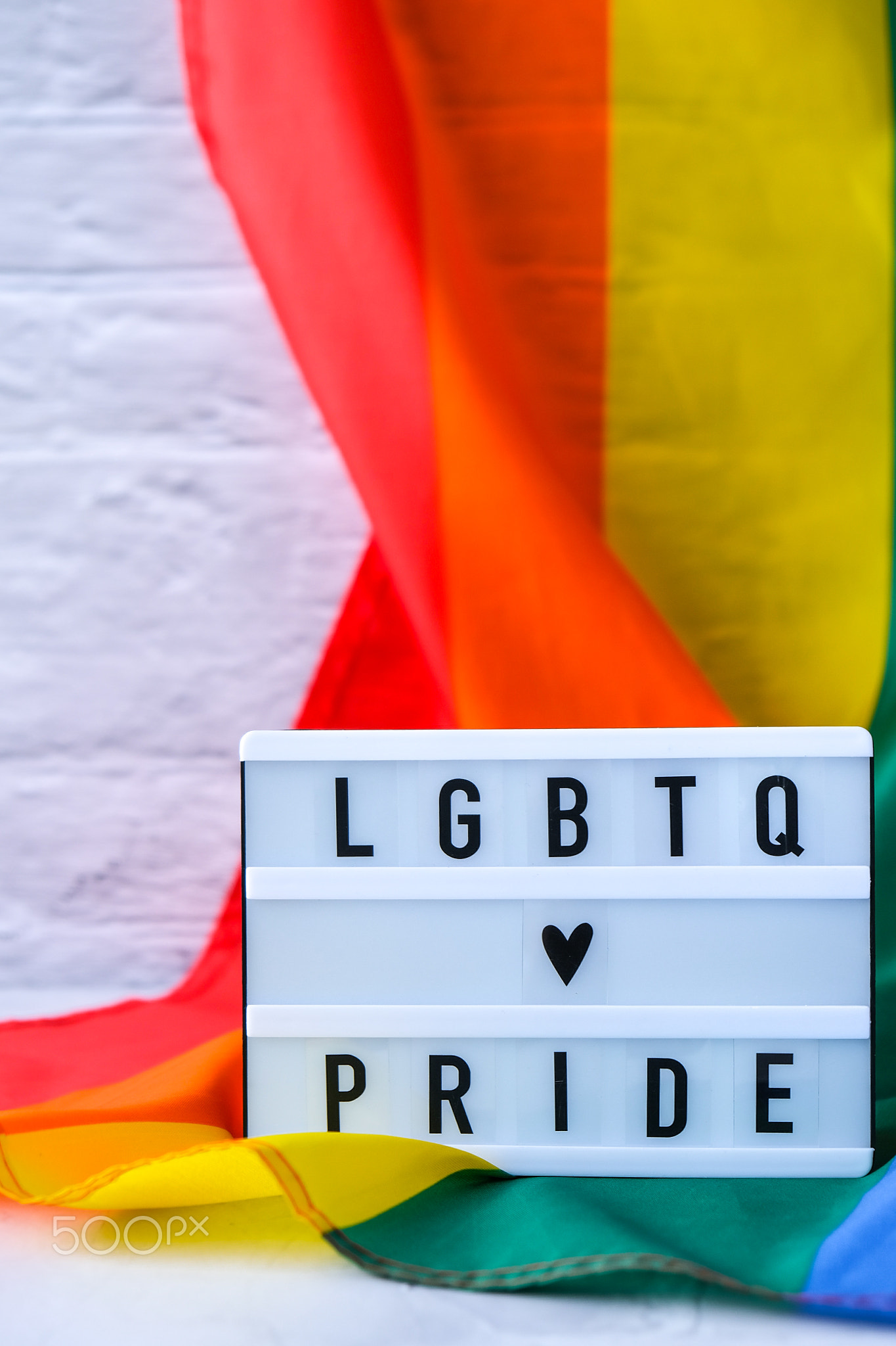 Rainbow flag with lightbox and text LGBTQ PRIDE. Rainbow lgbtq flag