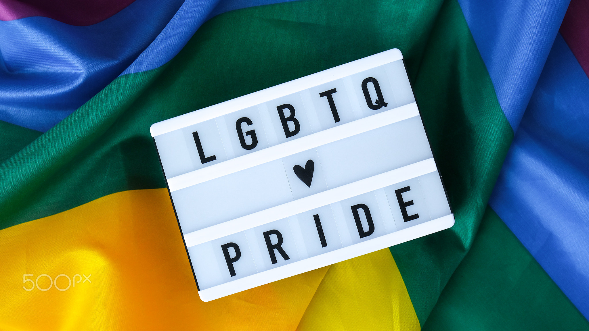 Rainbow flag with lightbox and text LGBTQ PRIDE. Rainbow lgbtq flag
