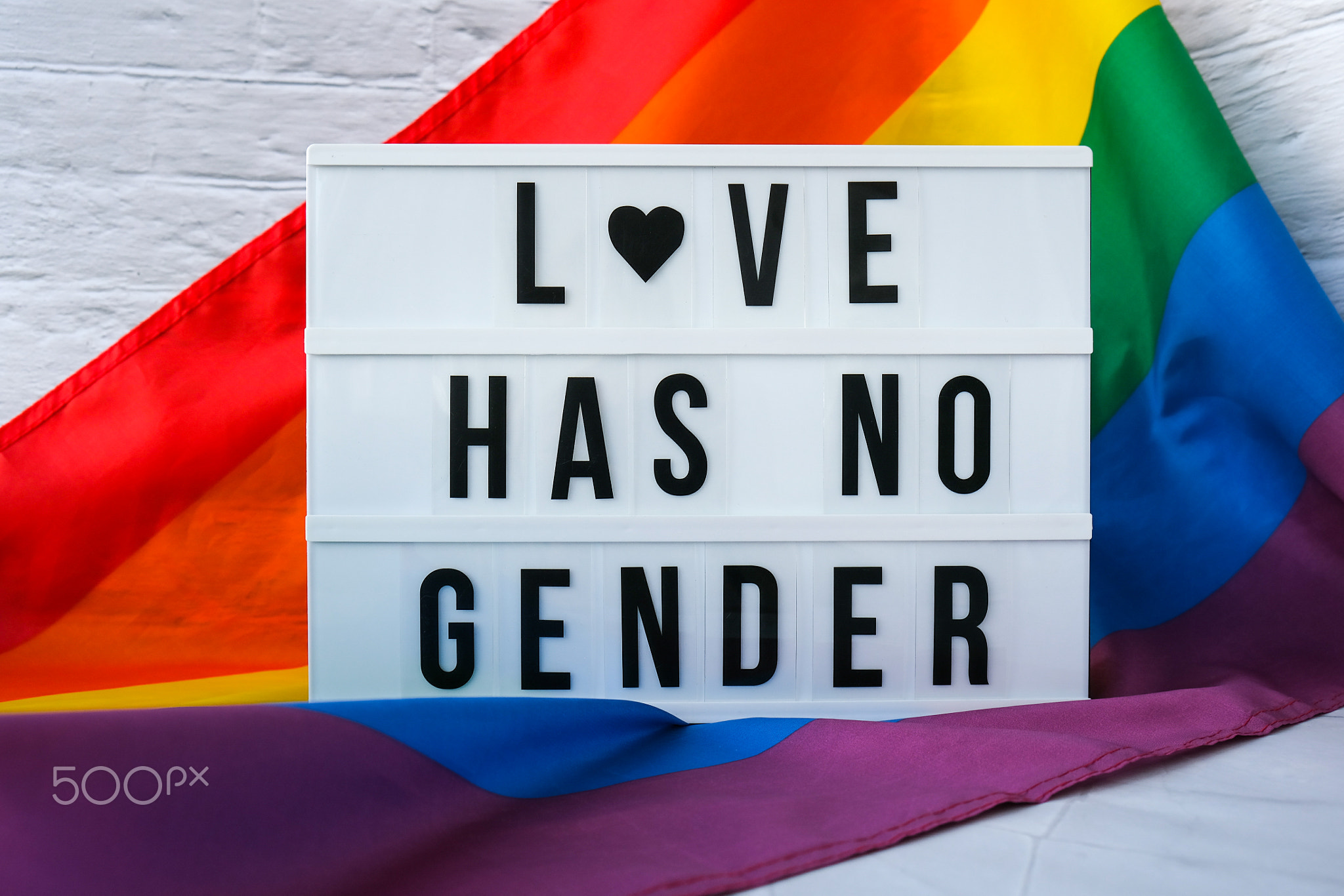 Rainbow flag with lightbox and text LOVE HAS NO GENDER. Rainbow lgbtq