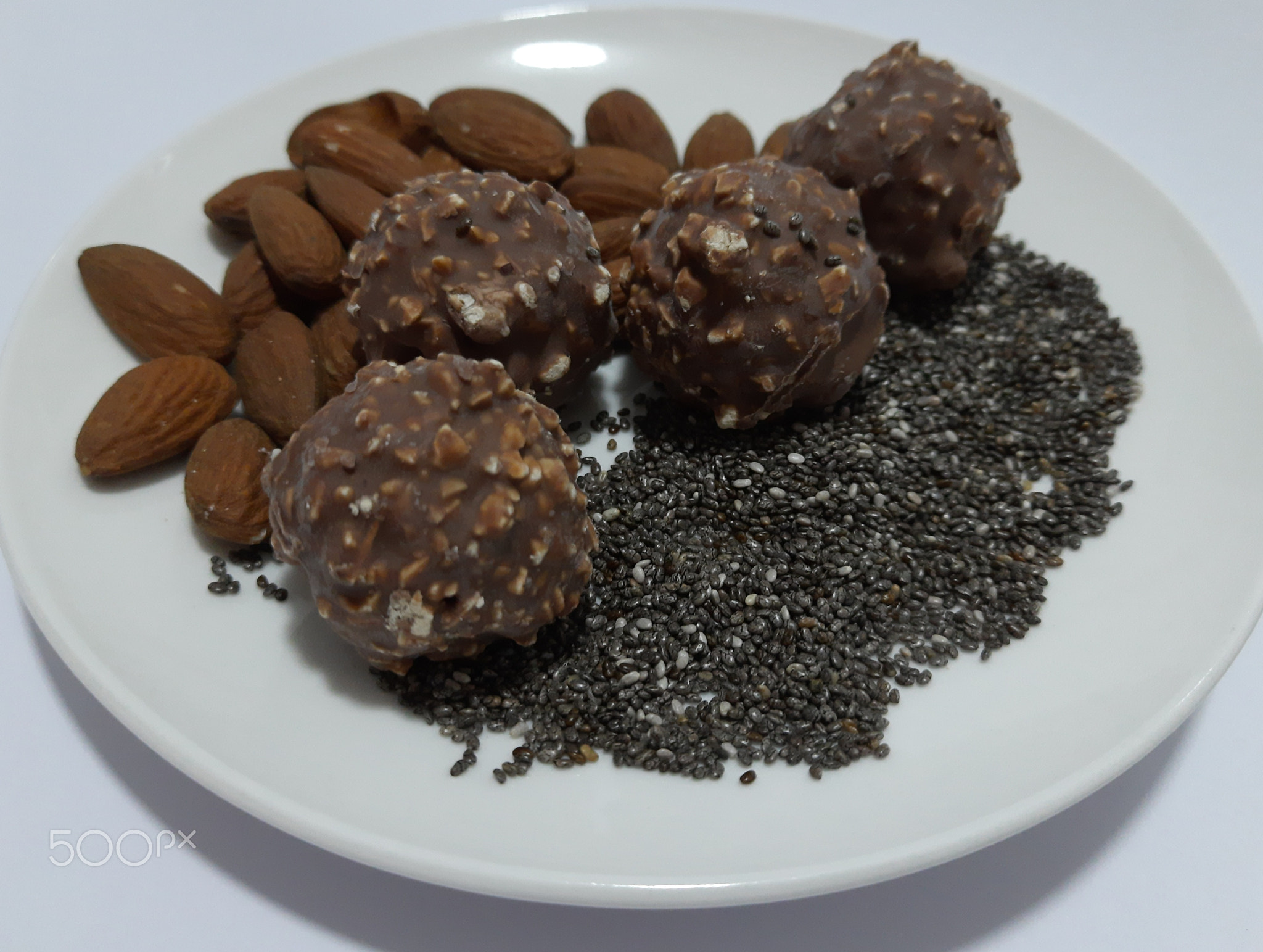 delicious luxury dessert, chocolate, almonds, honey, chia seeds, healthy versus unhealthy food