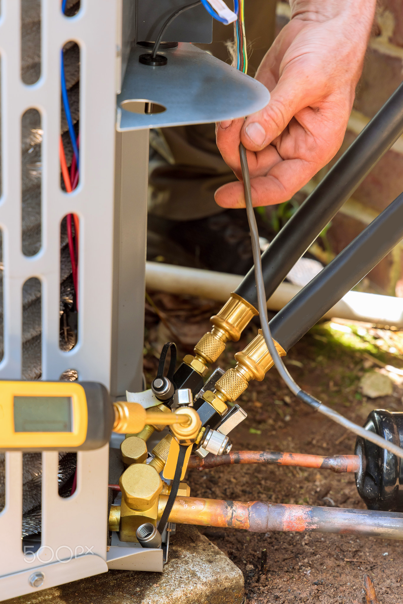 Technician in connecting outdoor new air conditioning unit