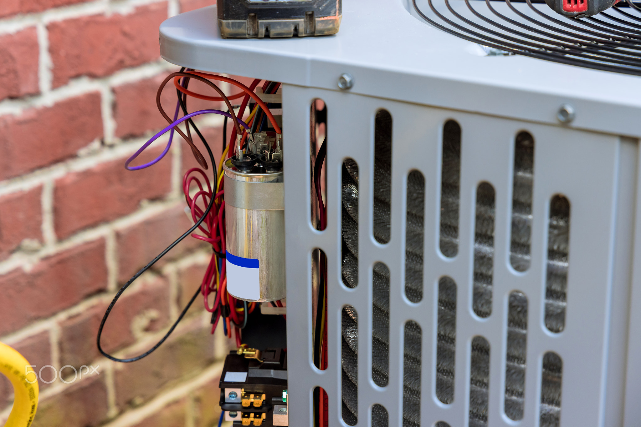 Technician repairing the air conditioner outdoors