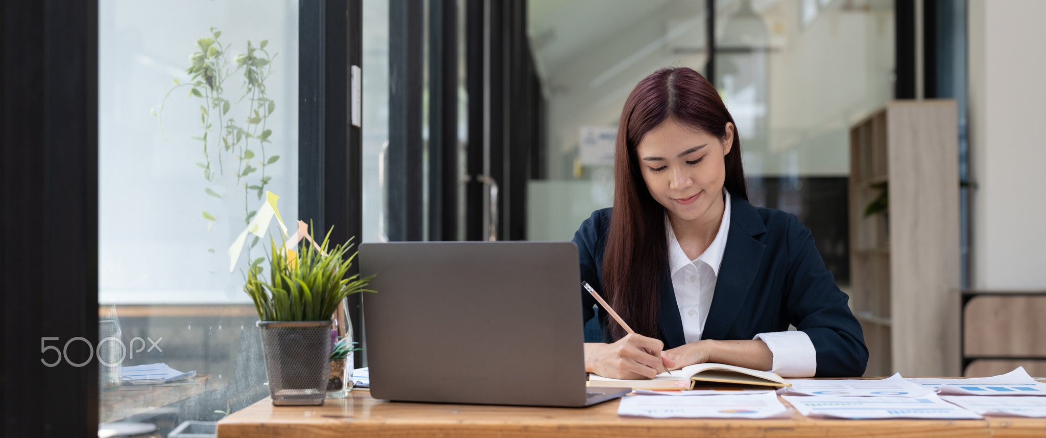 Business accountant asian woman using calculator for do math finance