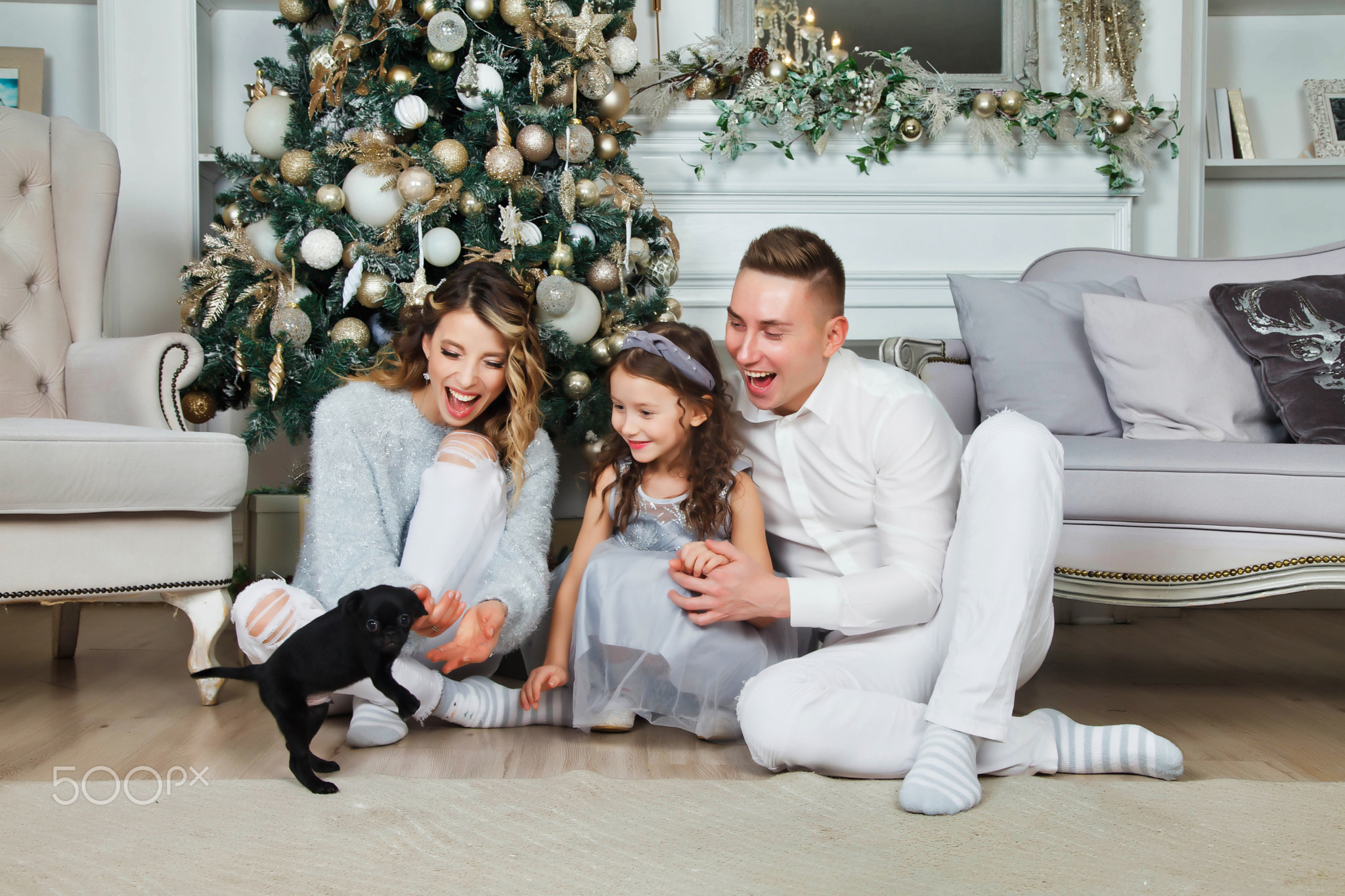 Happy family with Christmas gifts on floor at home on Merry Christmas and Happy New Year