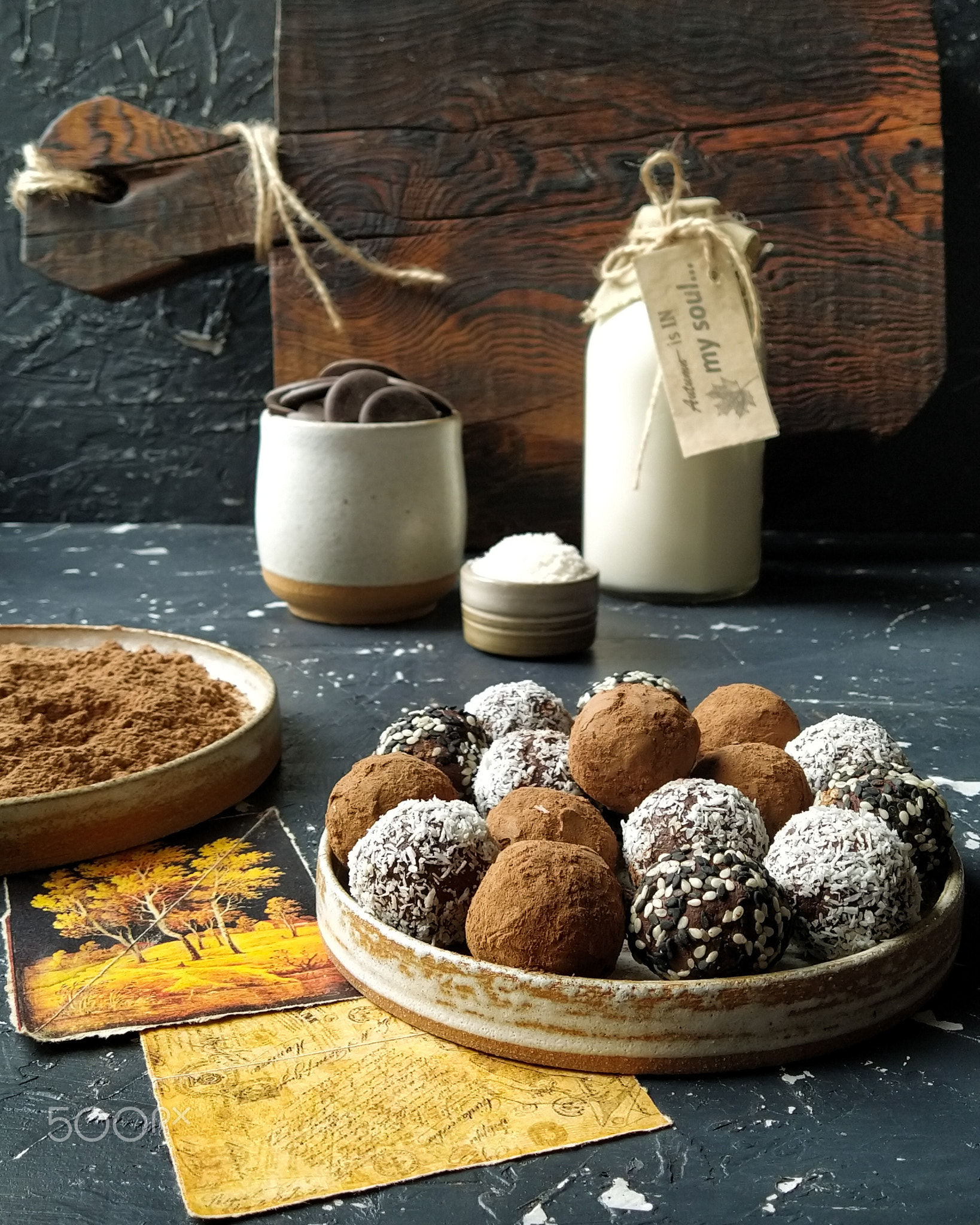Chocolate truffles with cooking ingredients on a dark background.