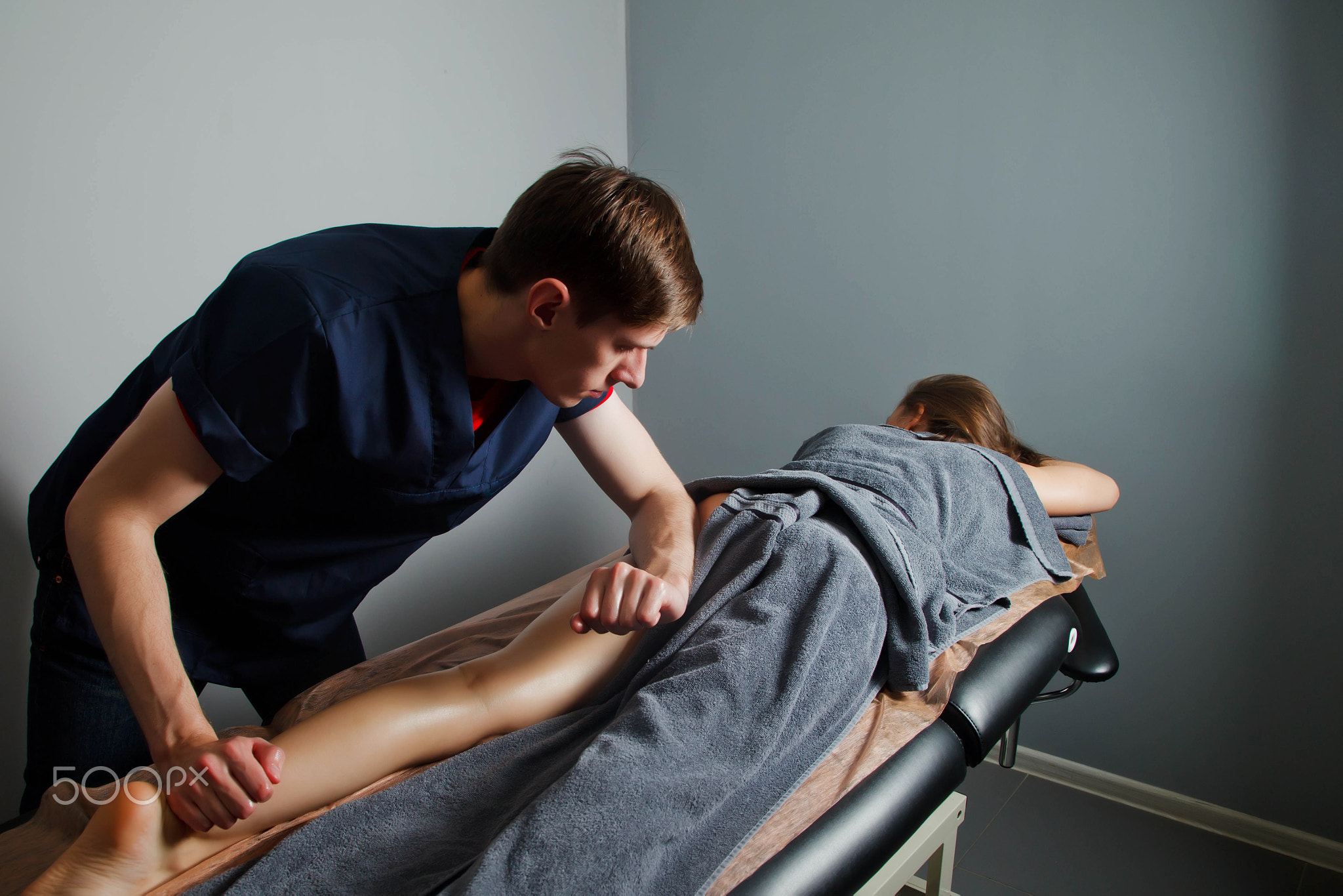 Sports Wellness massage in medical room of fitness gym