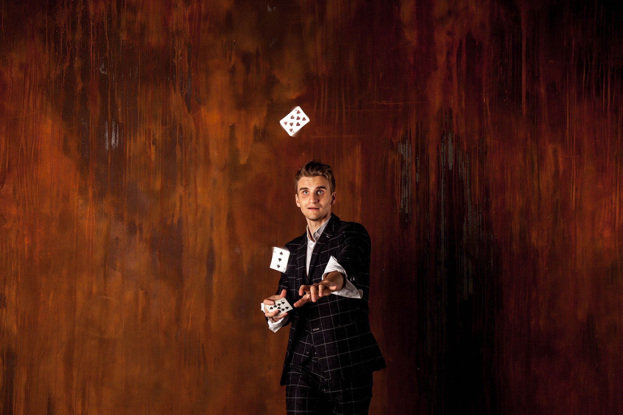 Close-up portrait of young man with gambling cards