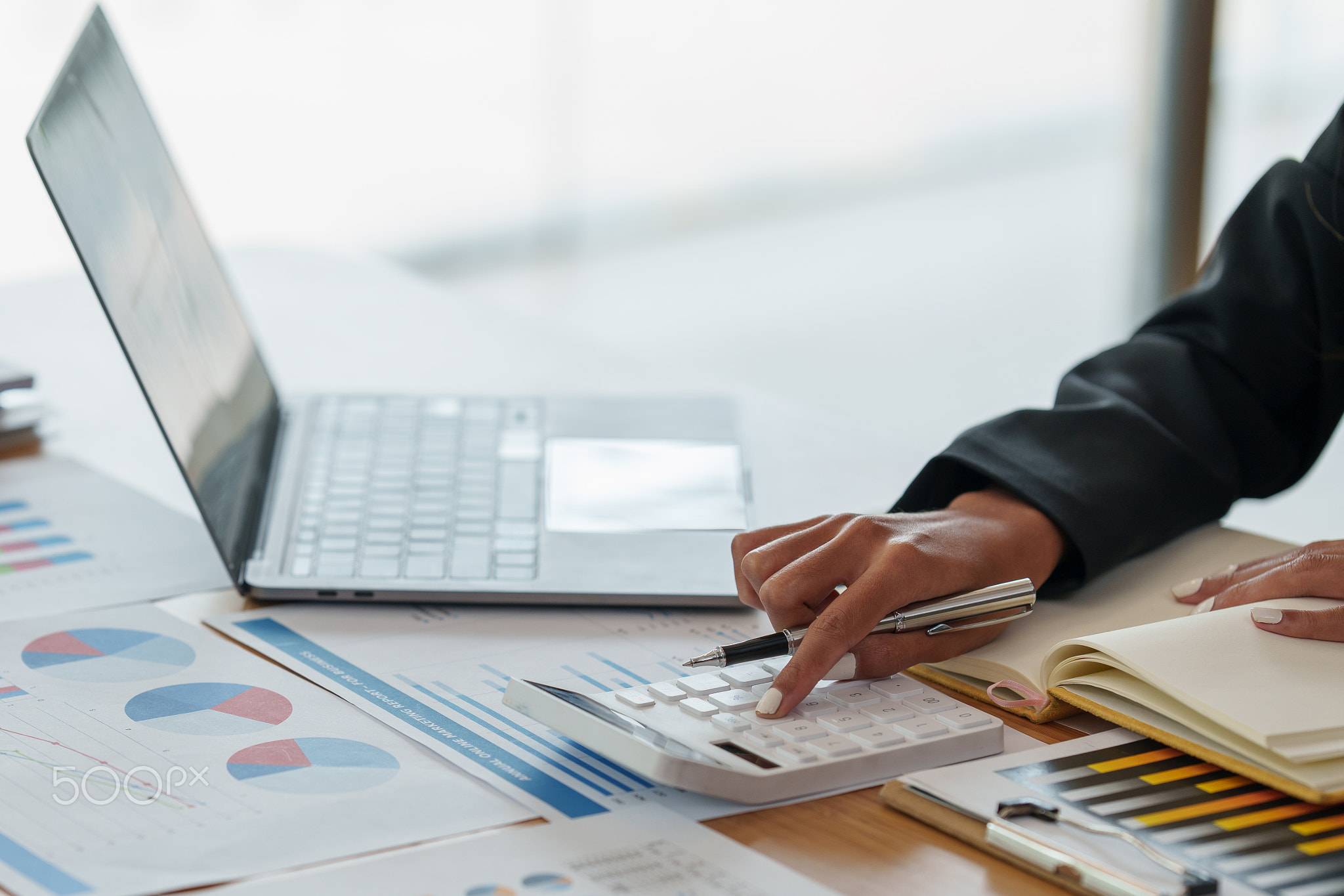 Close up Business woman hand using calculator to calculate the company