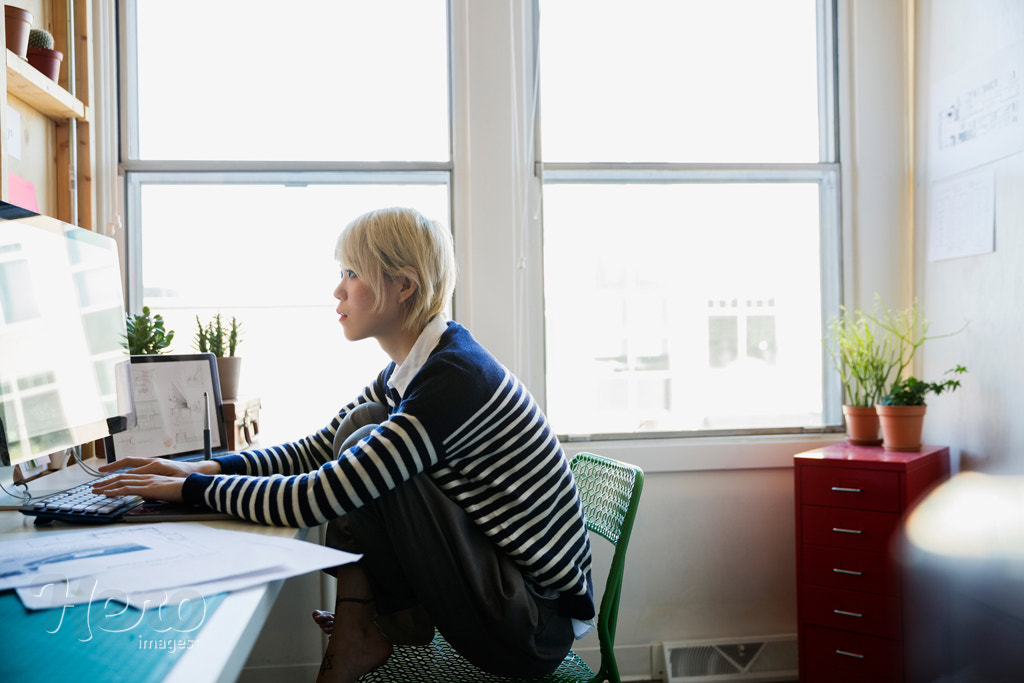 Designer working at computer in office by Hero Images Hero Images on 500px.com