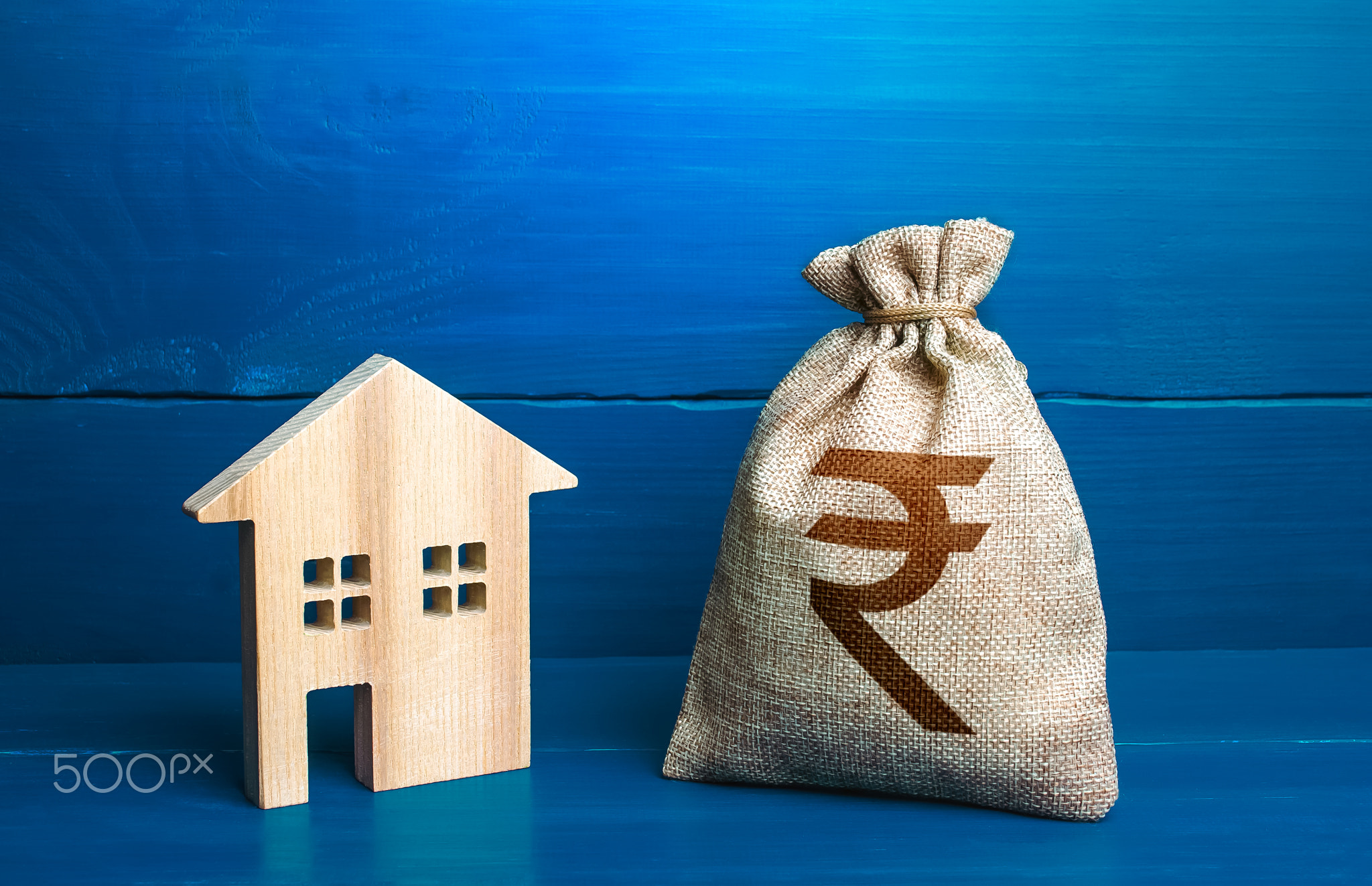 Figurine silhouette house and indian rupee money bag