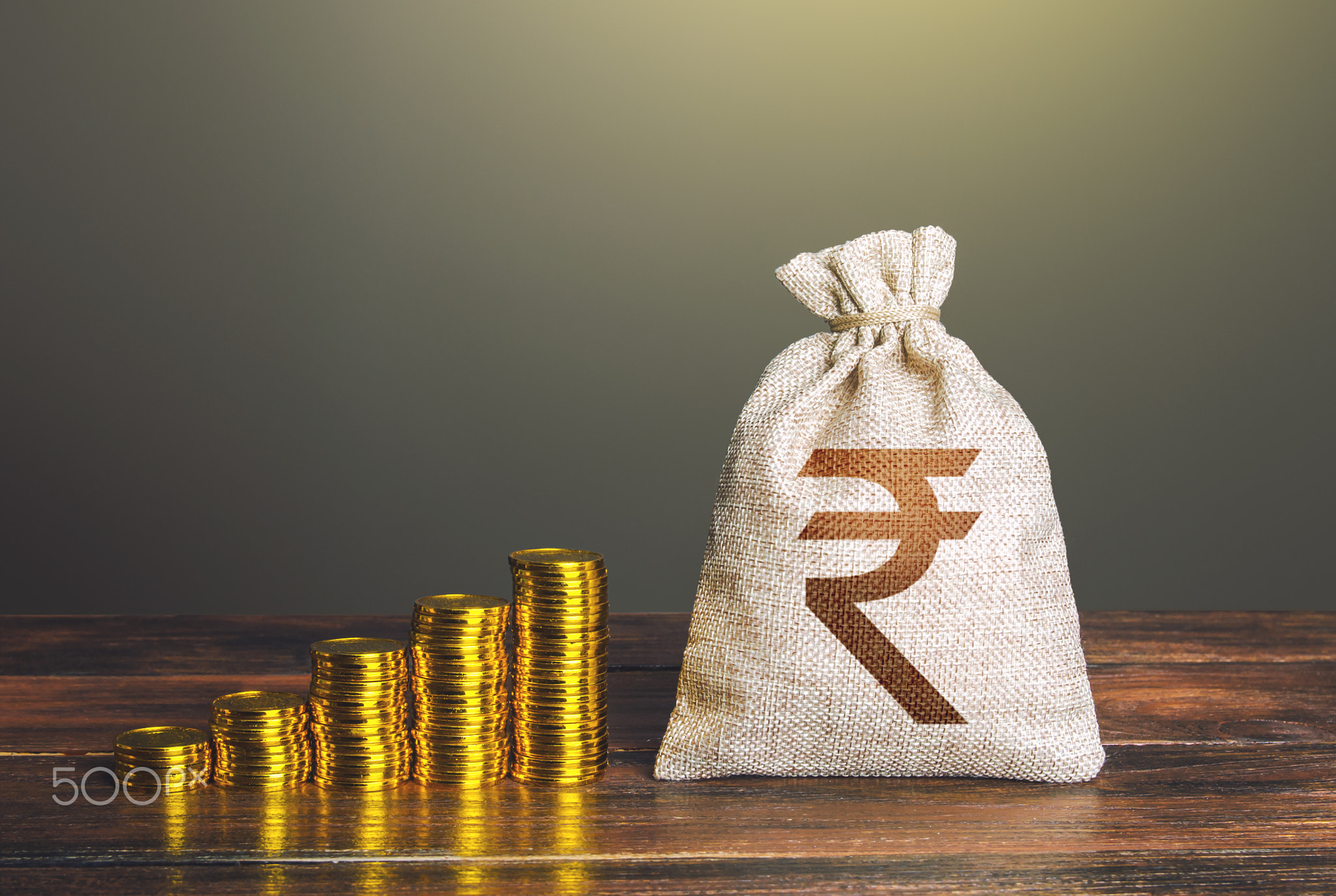 Indian rupee money bag and increasing stacks of coins