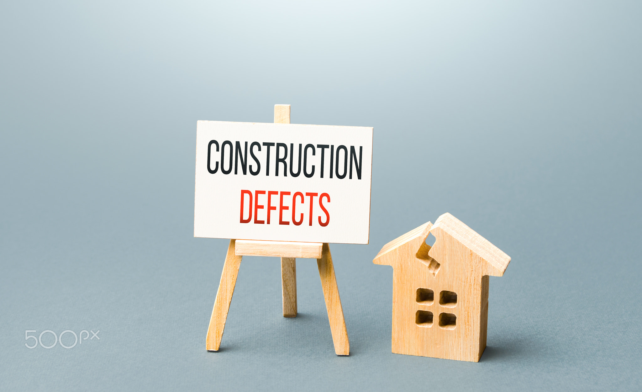 Cracked house and construction defects sign. 
