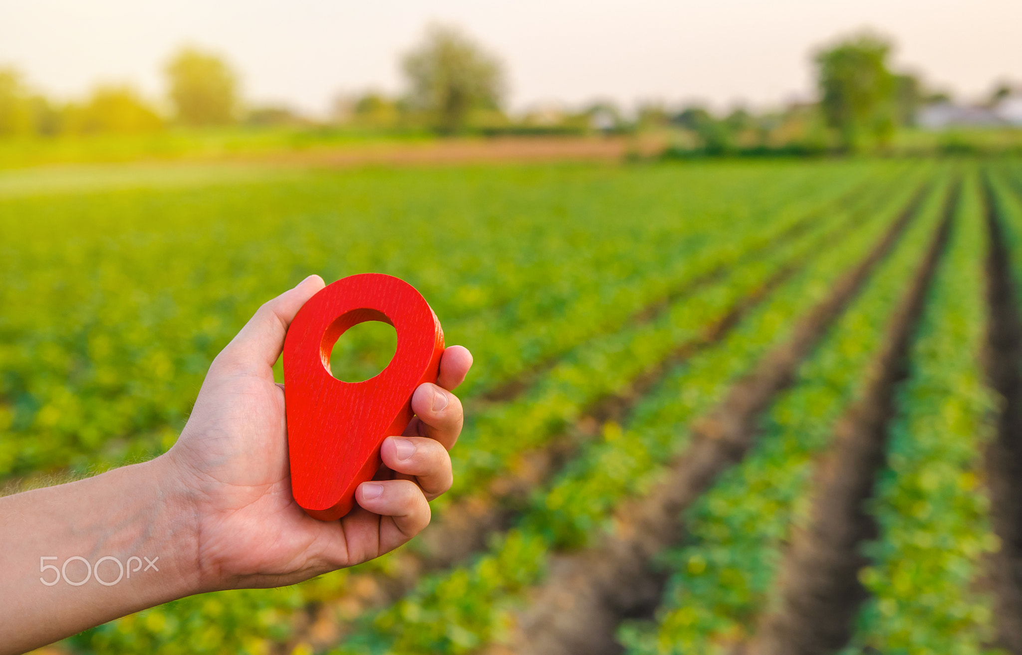 Red location pin on farm field.