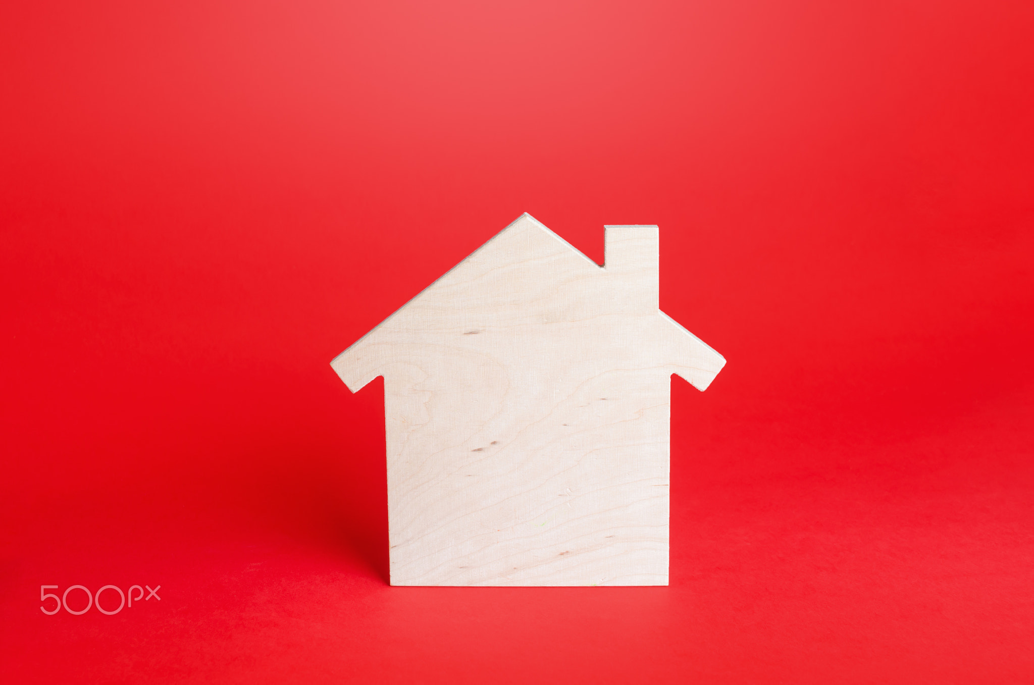 Empty blank wooden house on red background.