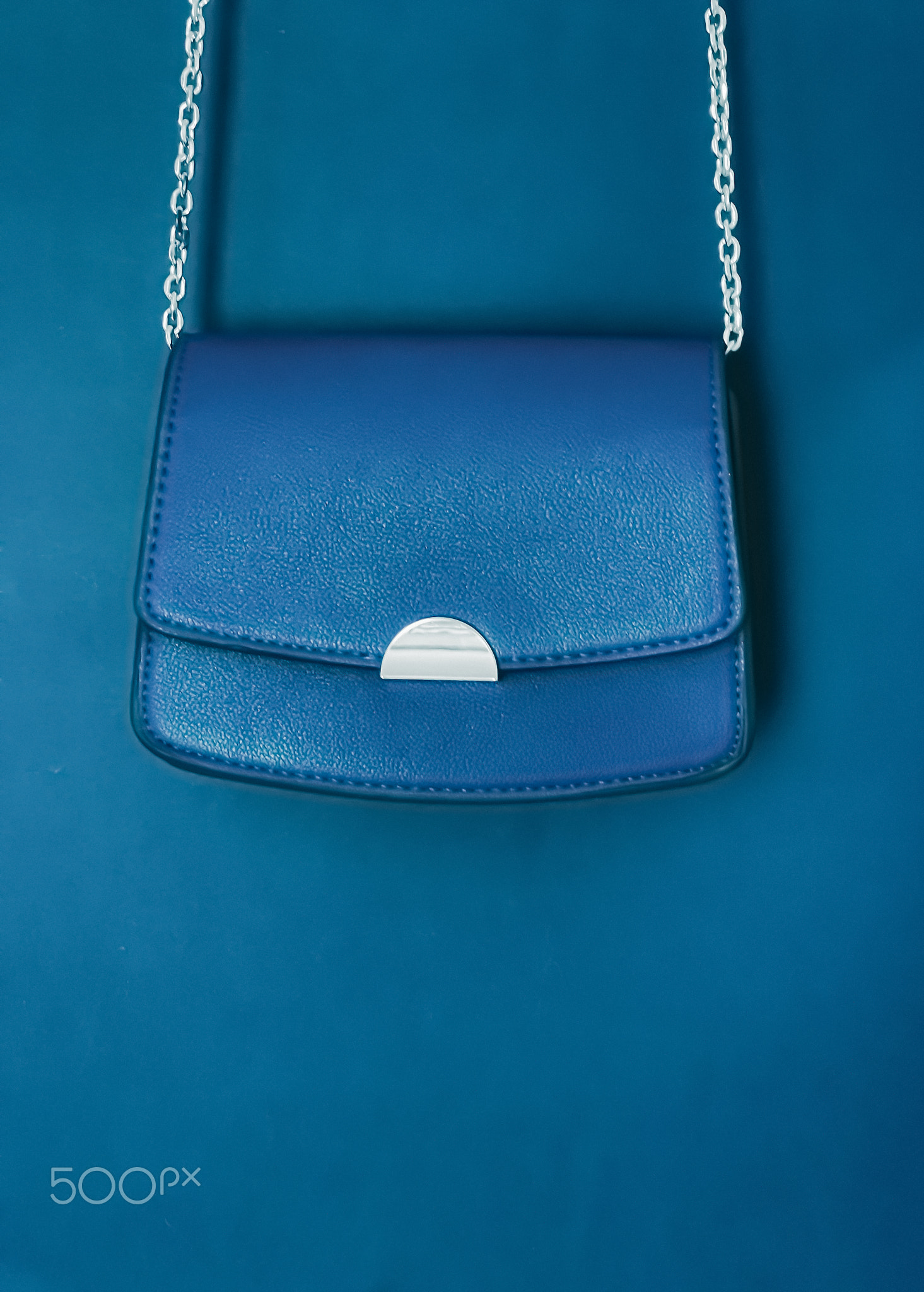 Blue fashionable leather purse with silver details as designer bag and