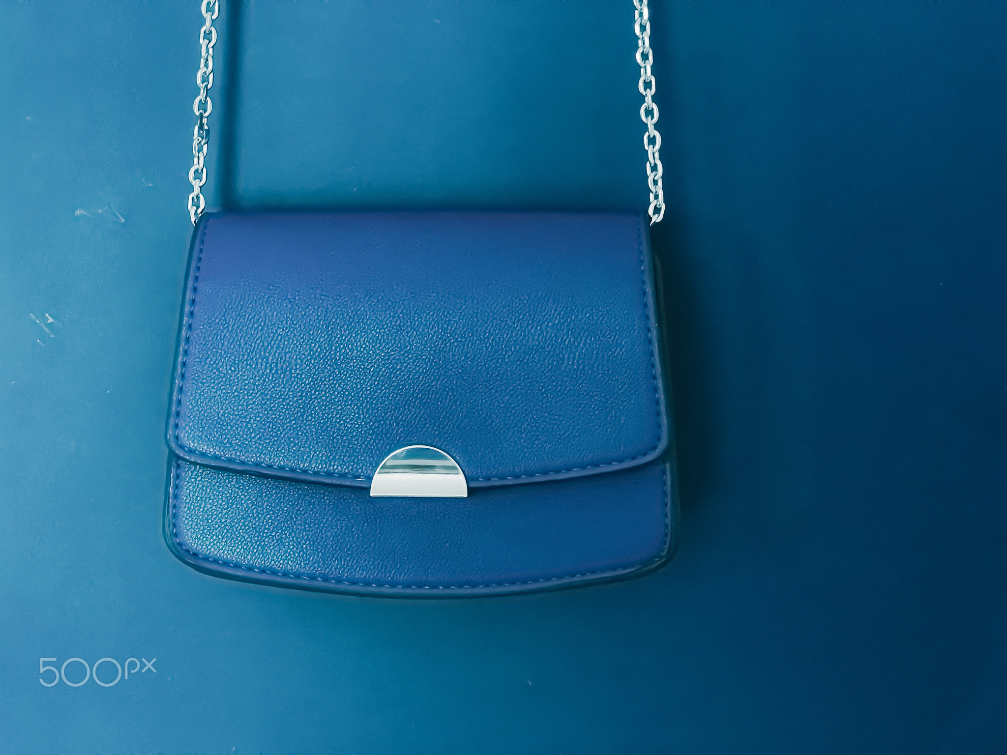 Blue fashionable leather purse with silver details as designer bag and