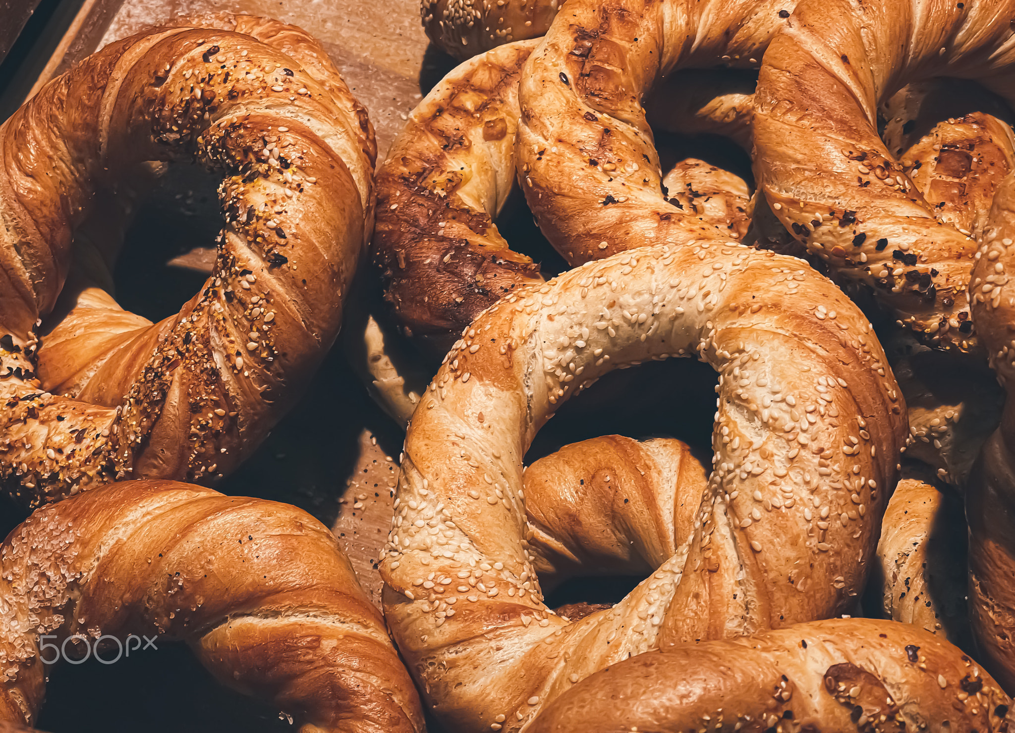 Fresh loaves of bread and buns in rustic bakery, baked goods on rustic