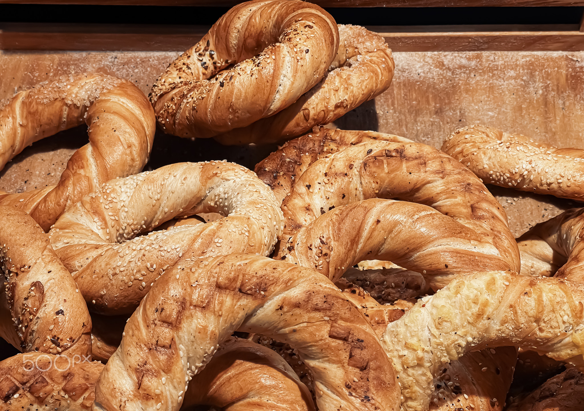 Fresh loaves of bread and buns in rustic bakery, baked goods on rustic