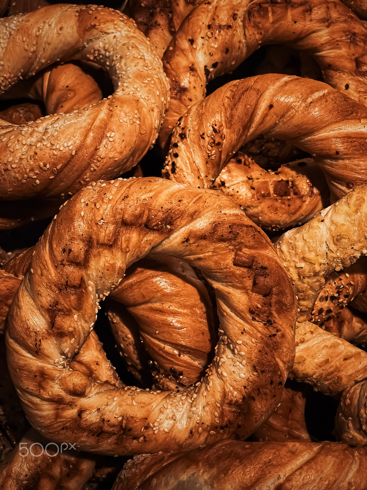 Fresh loaves of bread and buns in rustic bakery, baked goods on rustic