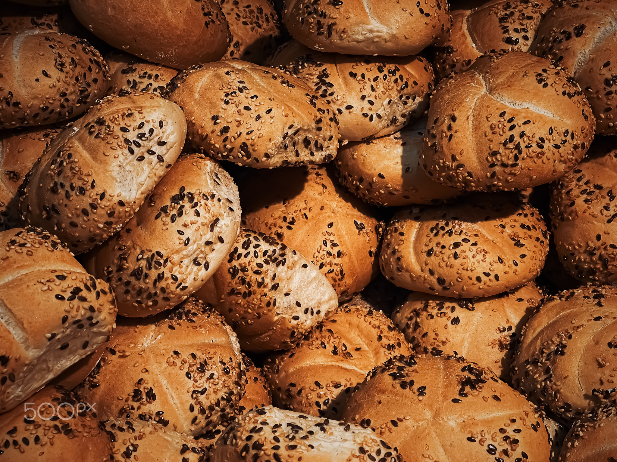 Fresh loaves of bread and buns in rustic bakery, baked goods on rustic