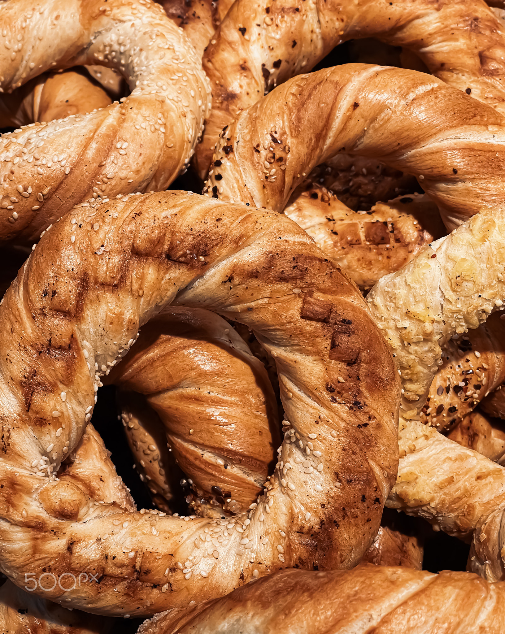 Fresh loaves of bread and buns in rustic bakery, baked goods on rustic