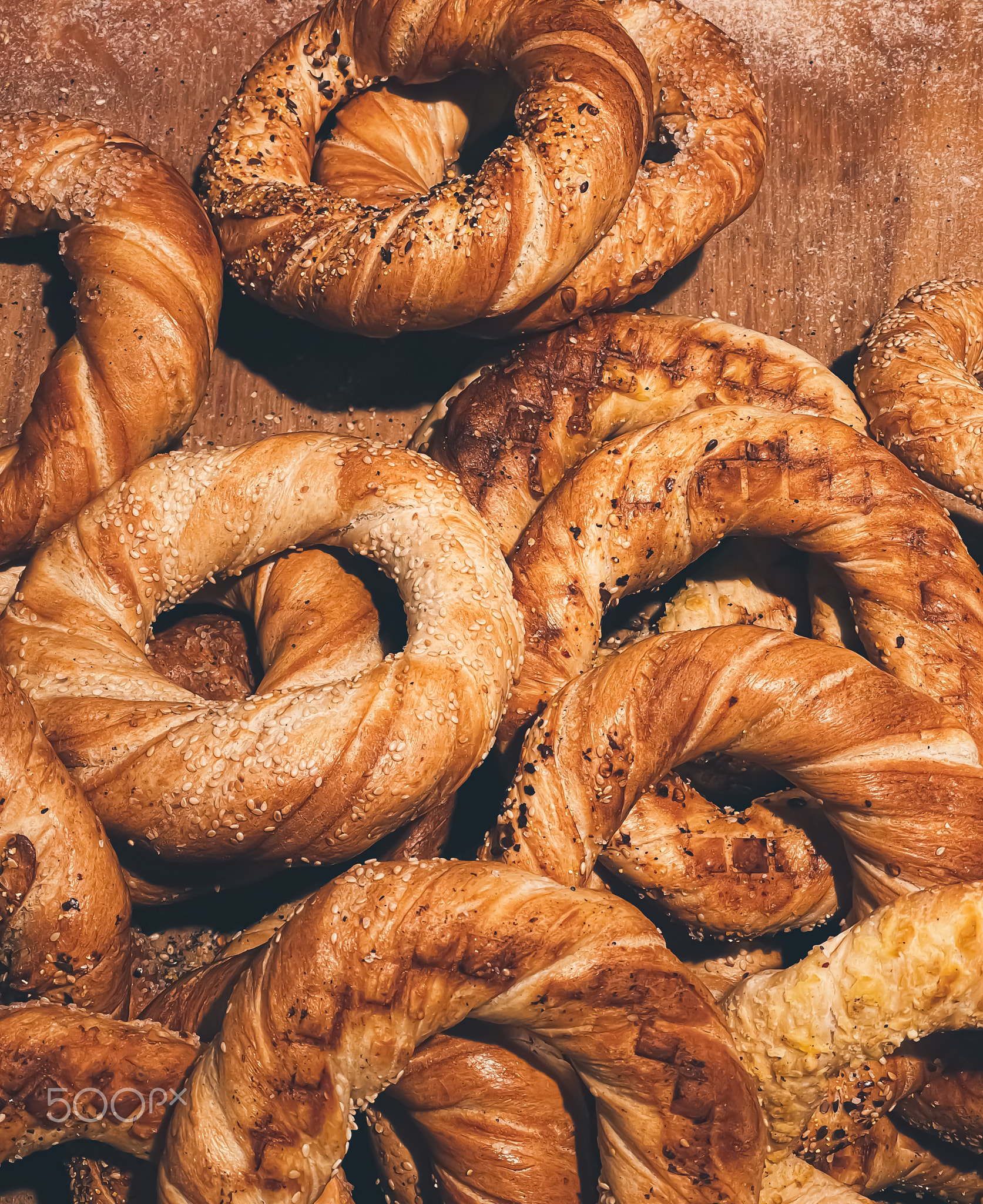 Fresh loaves of bread and buns in rustic bakery, baked goods on rustic