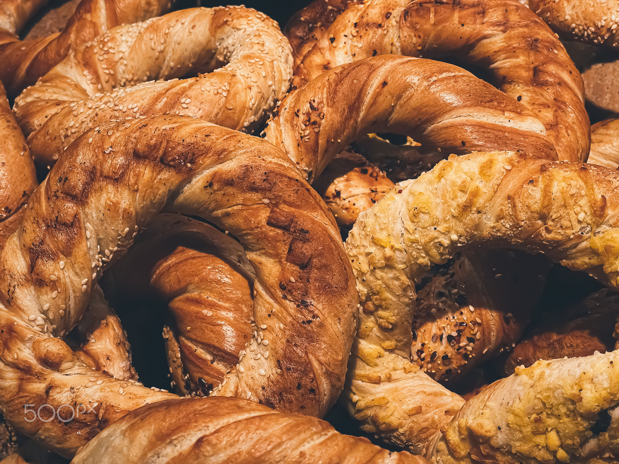 Fresh loaves of bread and buns in rustic bakery, baked goods on rustic