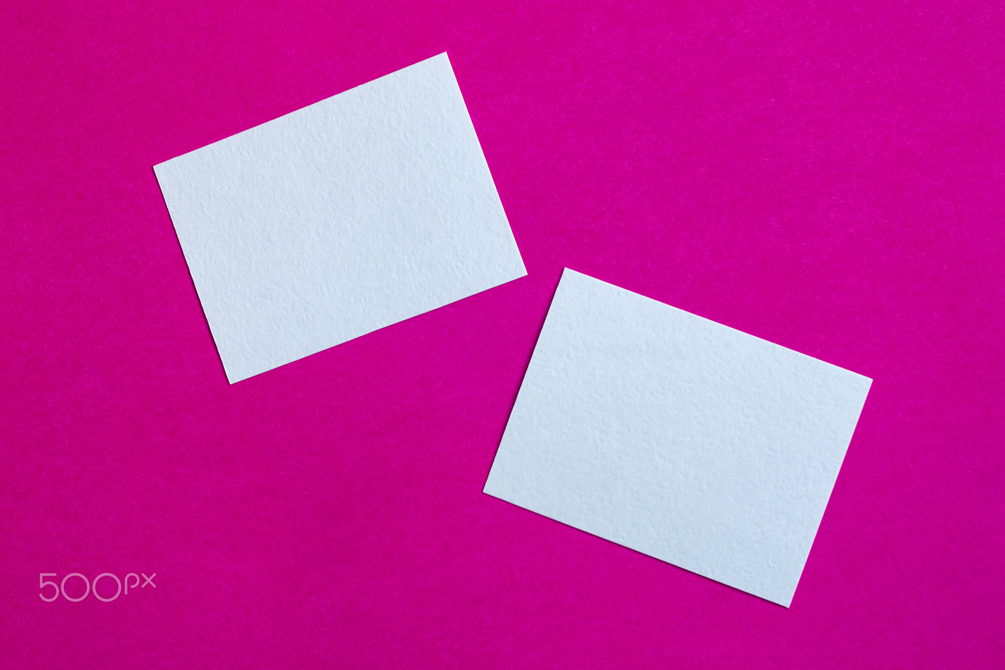 white paper cards or sticky notes on pink wall