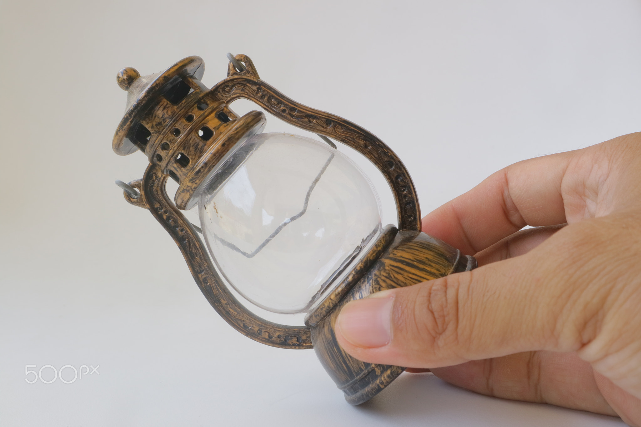 Miniature brown lantern on white isolated background