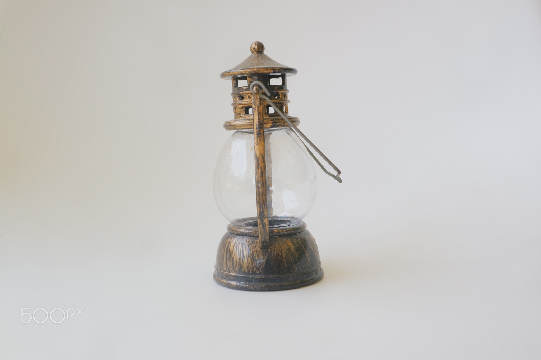 Miniature brown lantern on white isolated background