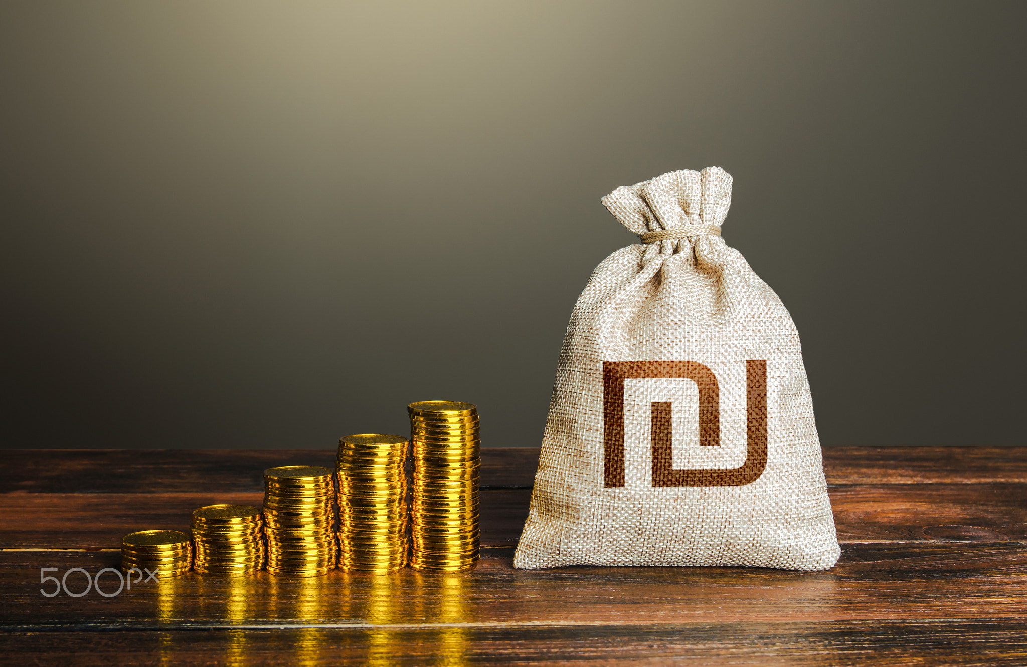 Israeli shekel money bag and increasing stacks of coins