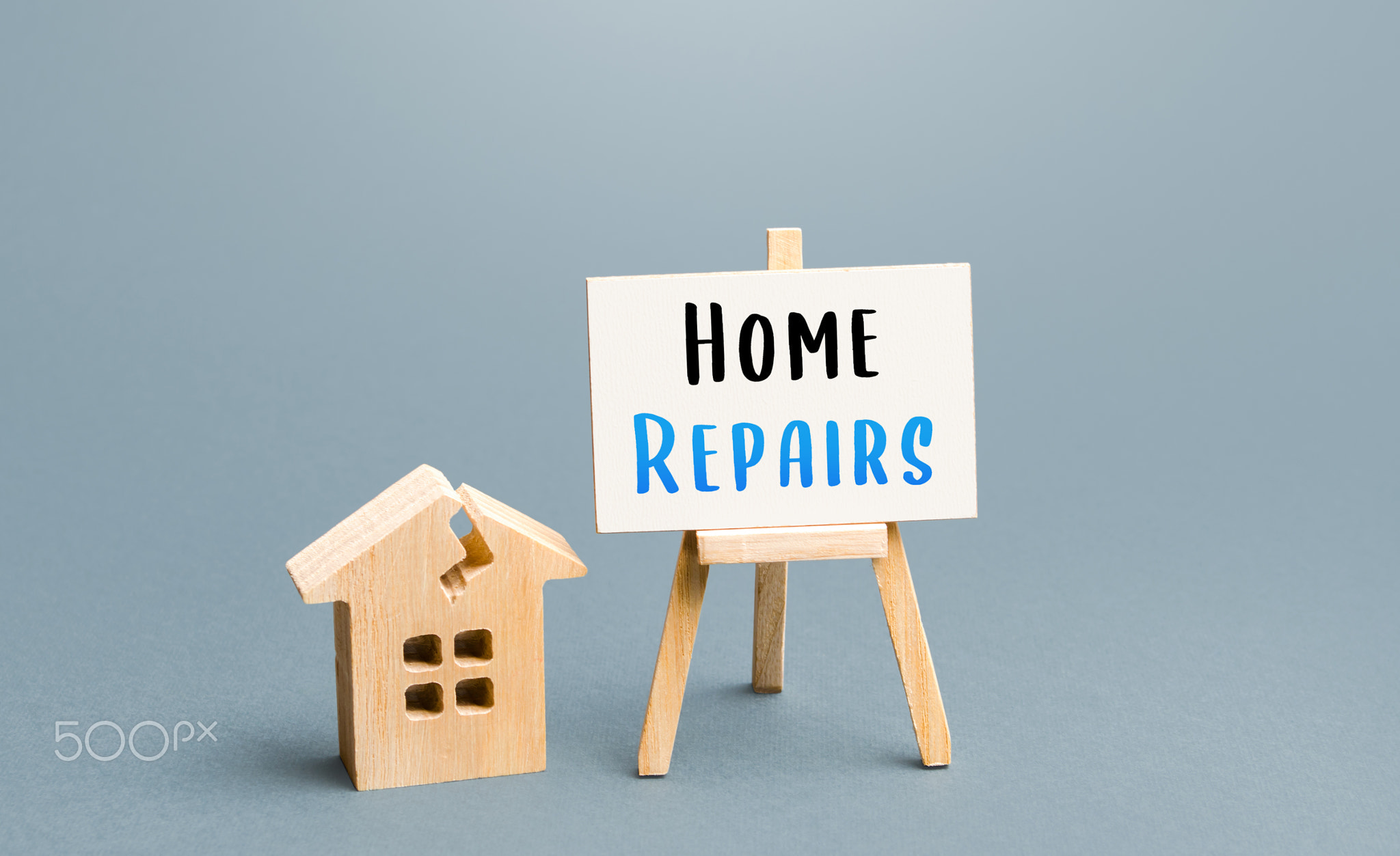 Cracked house and home repair sign. 
