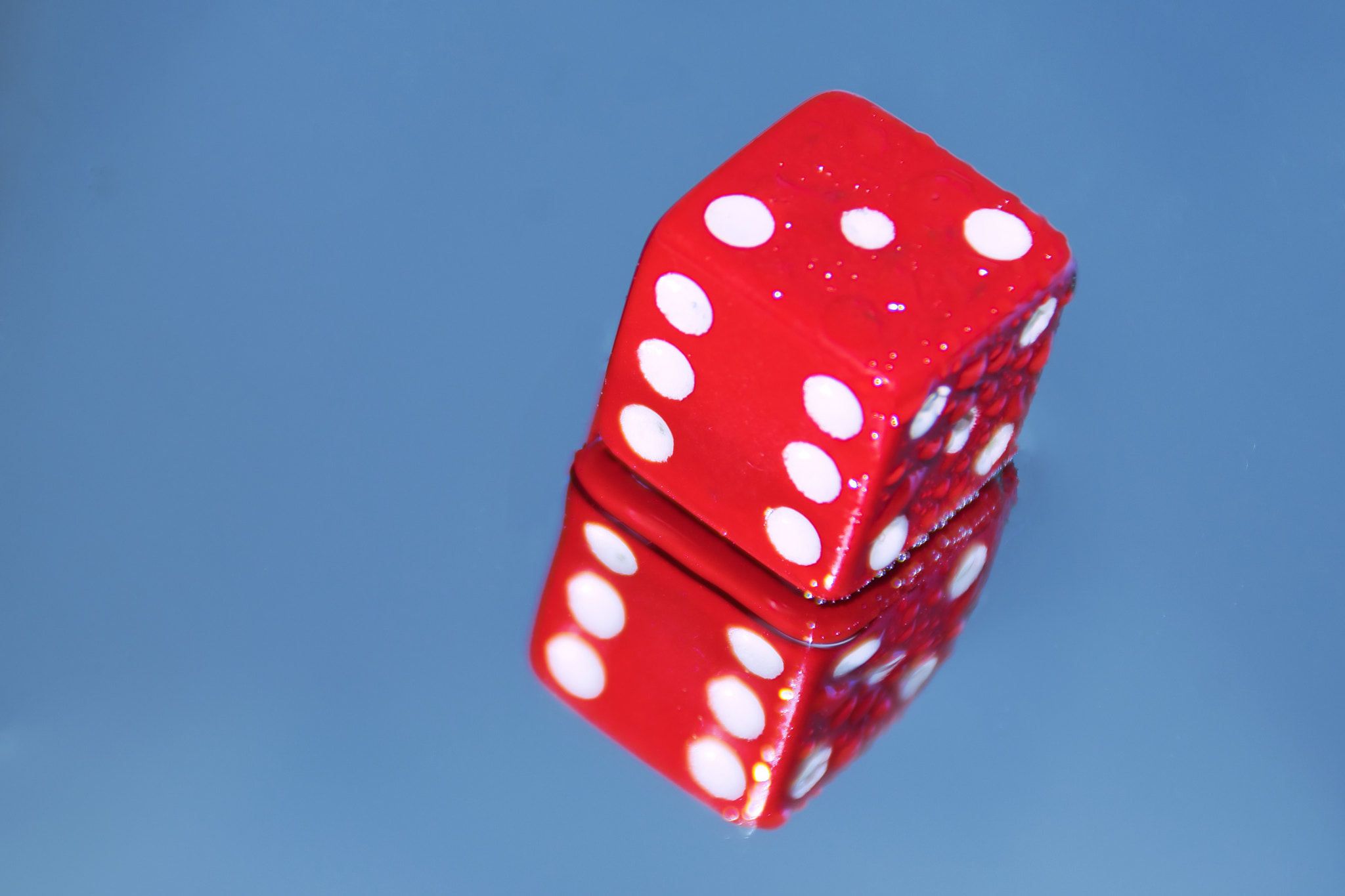 close-up of red dices against blue background