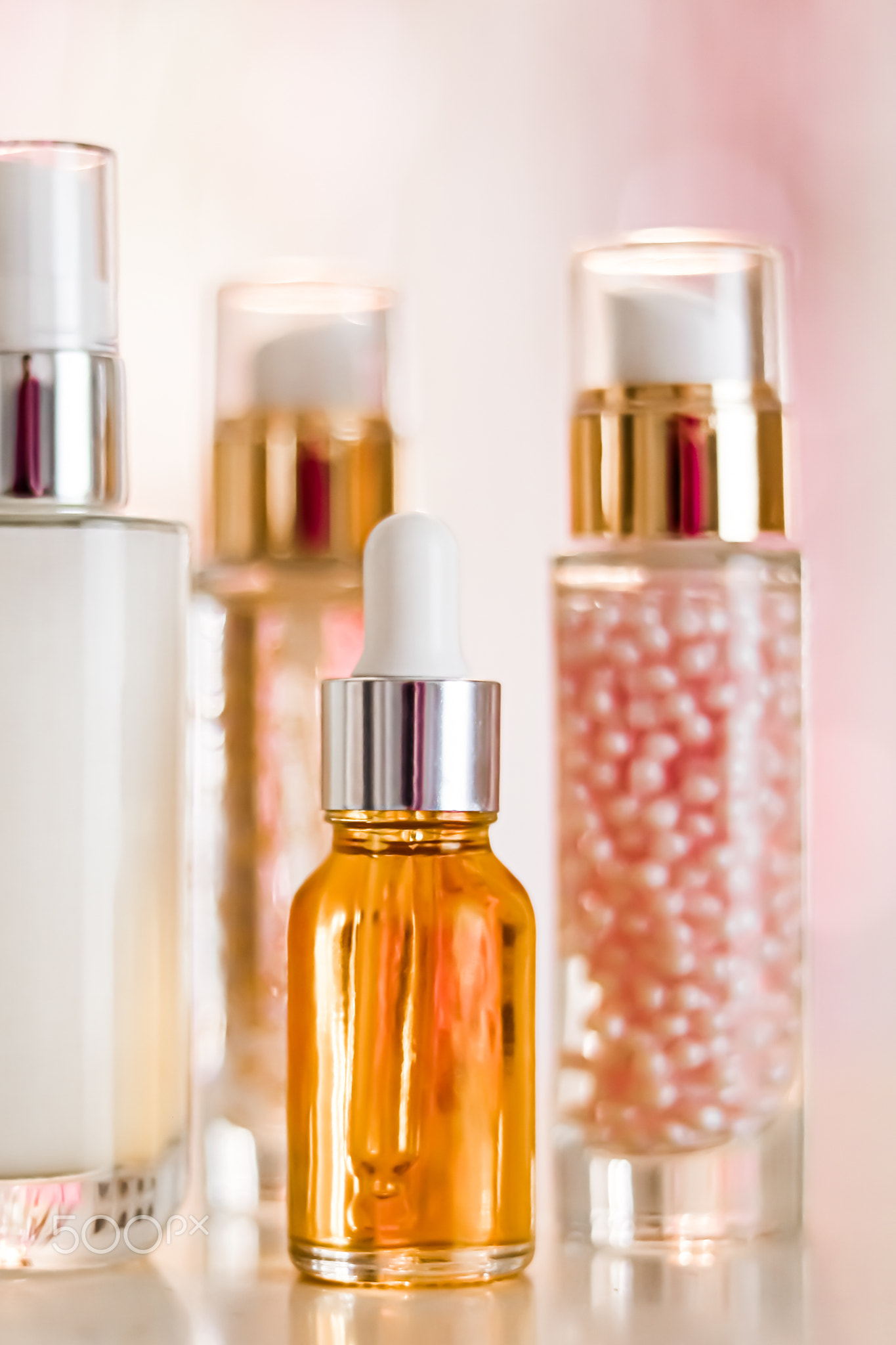 Skincare cosmetics products on glamour background, glass bottles with