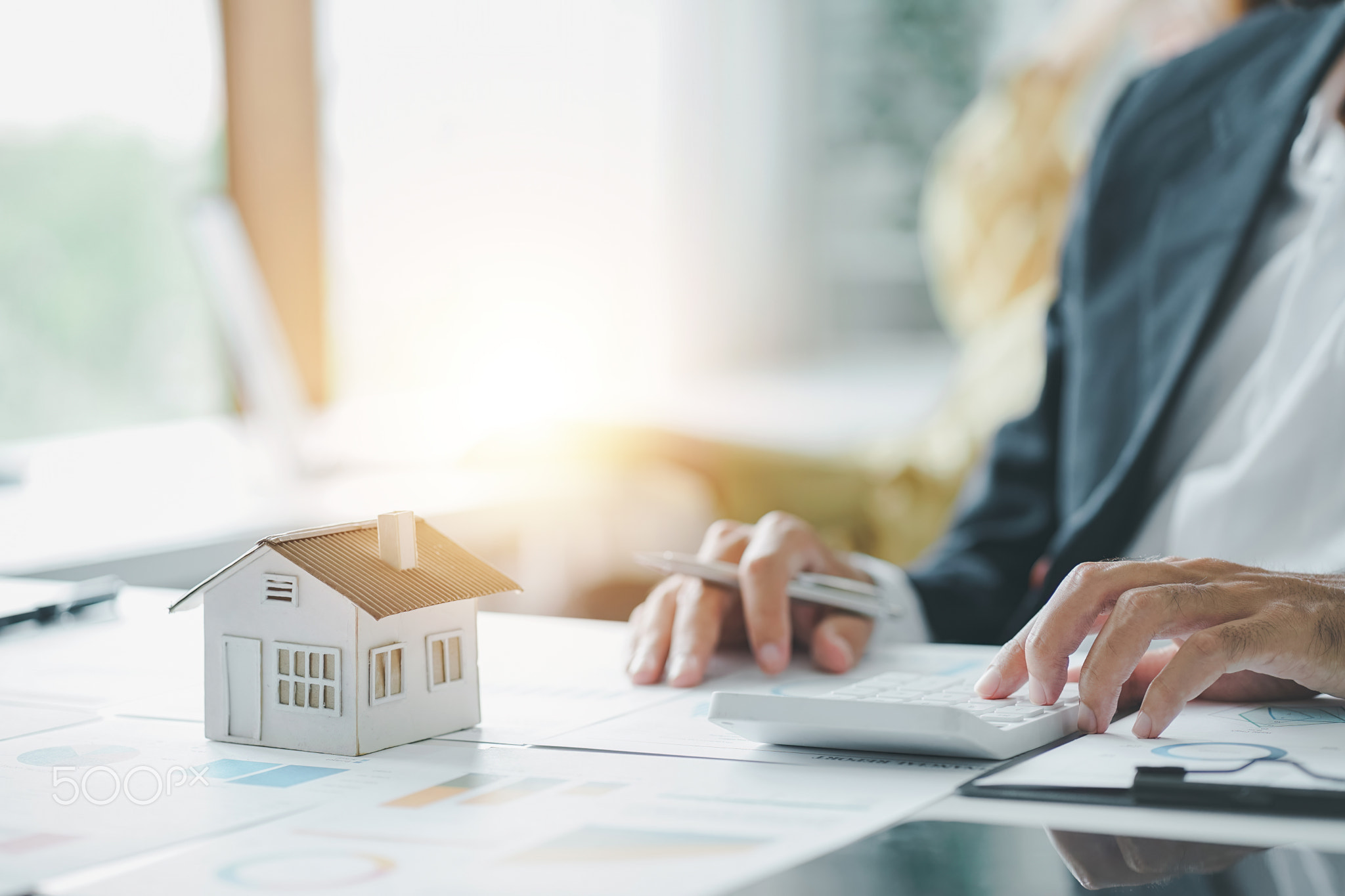 Cropped shot of estate agent using calculator calculate for contract