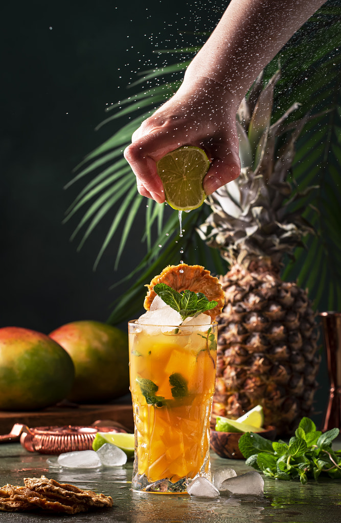 Summer cocktail with vodka, pineapple juice, mango, ice. Long drink or